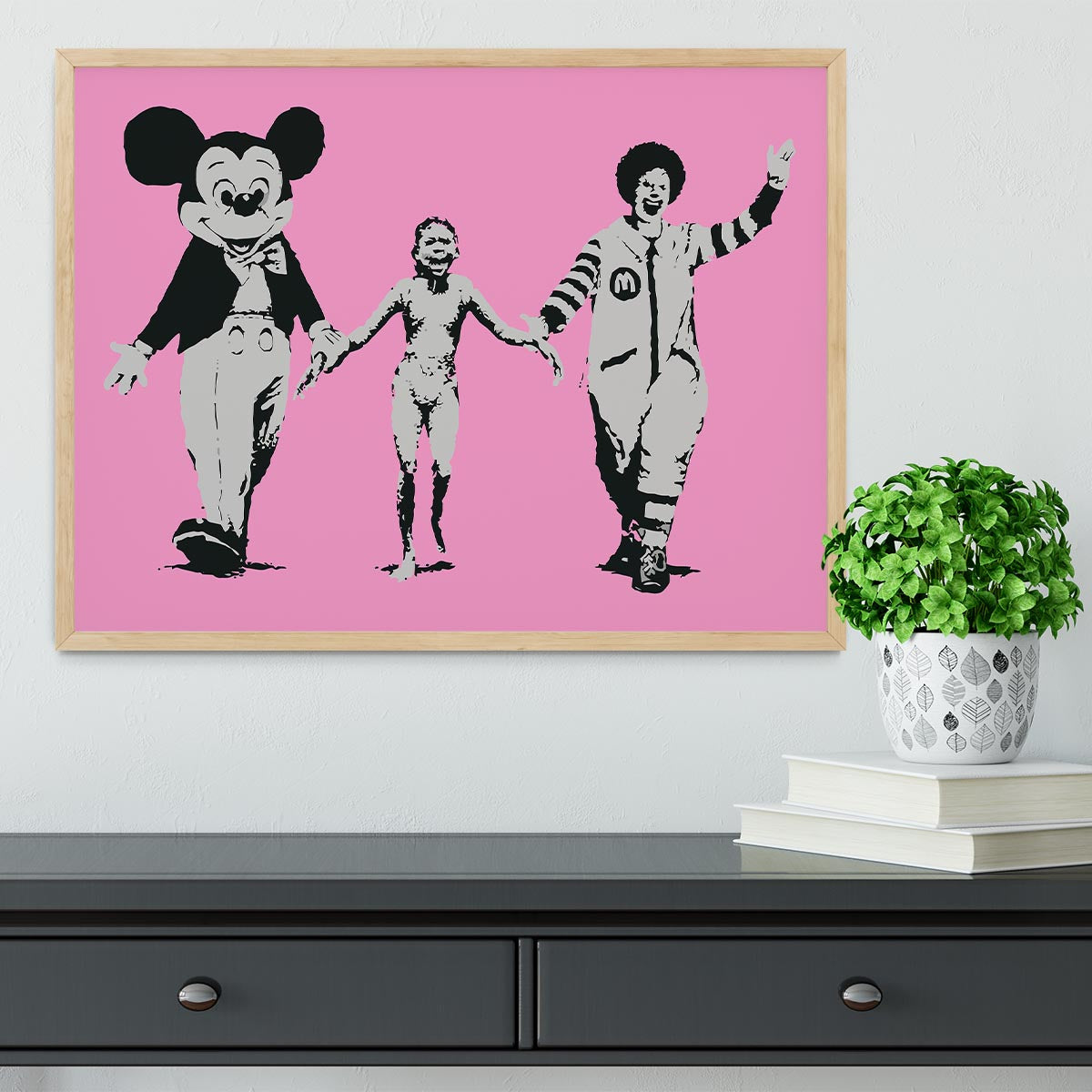 Banksy Mickey and Ronald Pink Framed Print featuring vibrant colors and a stylish handmade frame.