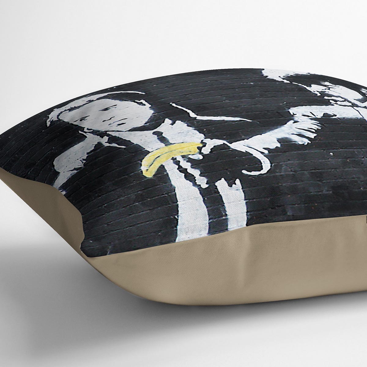 Banksy Pulp Fiction Banana Guns Cushion featuring vibrant banana gun design on luxurious vegan faux suede.