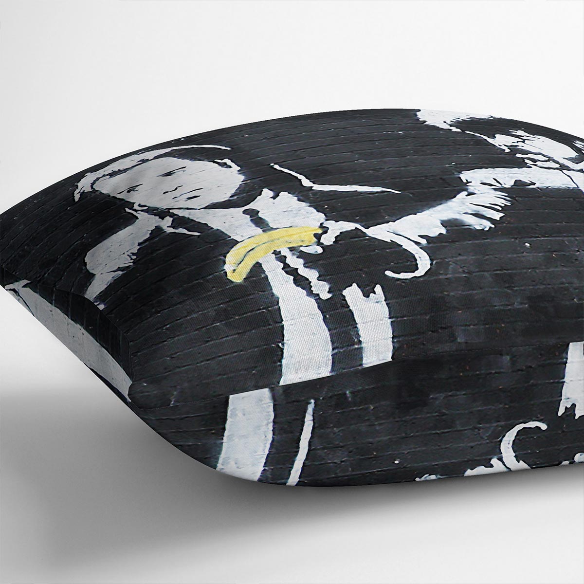 Banksy Pulp Fiction Banana Guns Cushion featuring vibrant banana gun design on luxurious vegan faux suede.