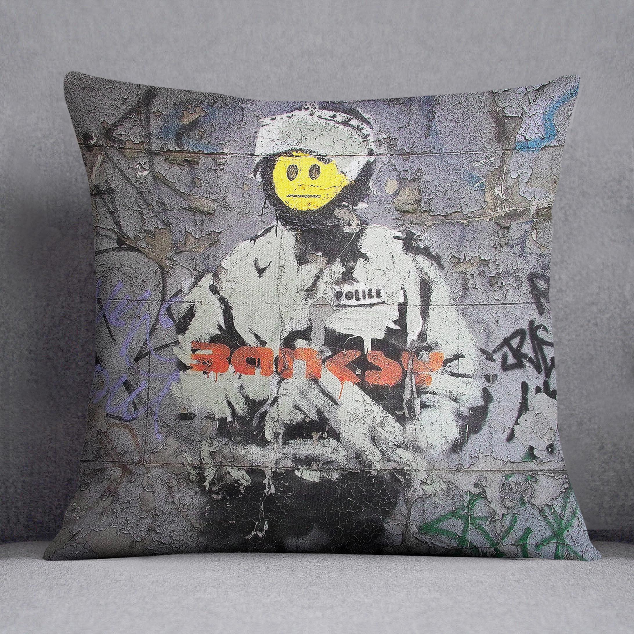 Banksy Smiley Riot Cop Cushion featuring vibrant colors and abstract design on luxurious vegan faux suede fabric.