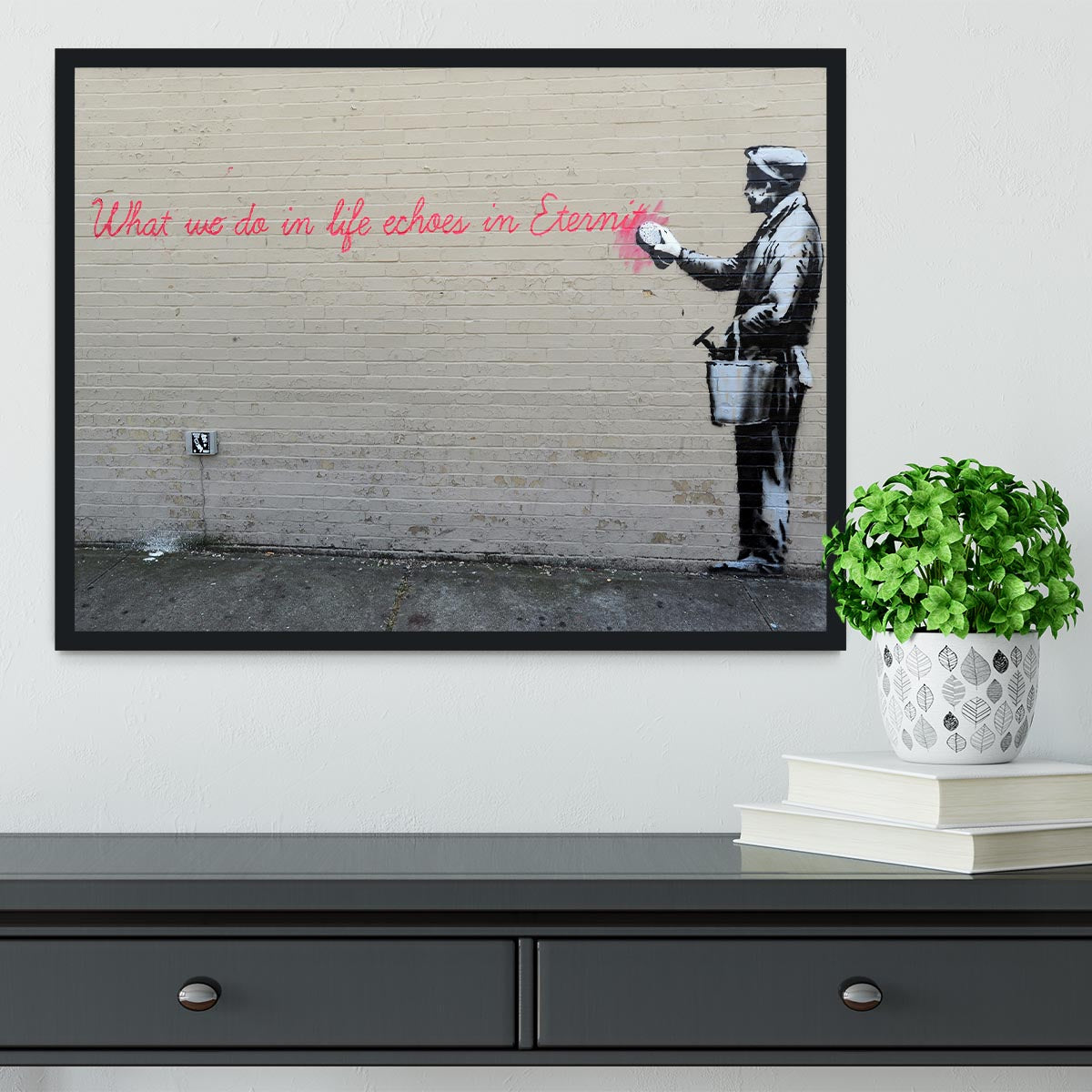 Banksy What We Do In Life Framed Print in a stylish black frame, showcasing vibrant colors and intricate details.