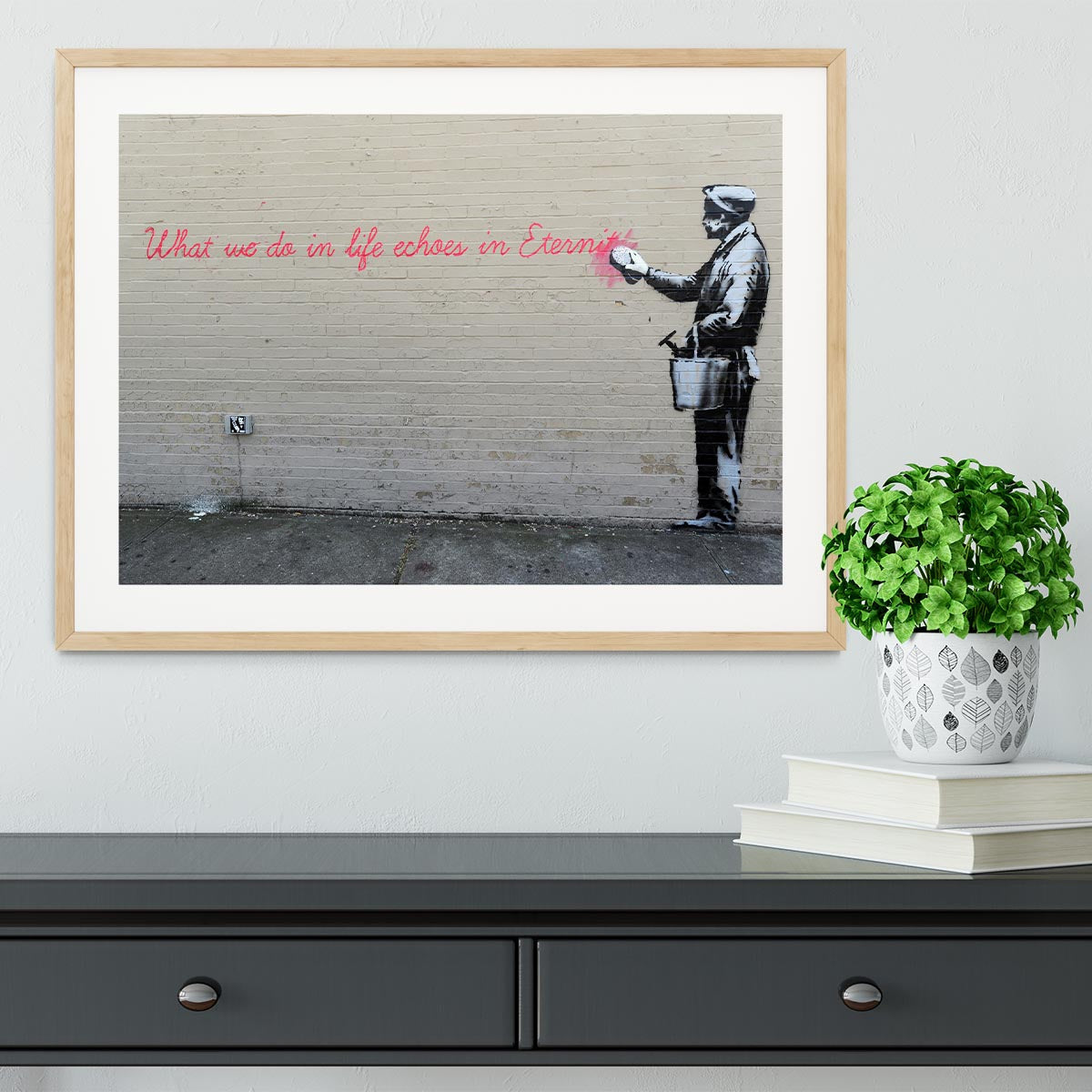 Banksy What We Do In Life Framed Print in a stylish black frame, showcasing vibrant colors and intricate details.