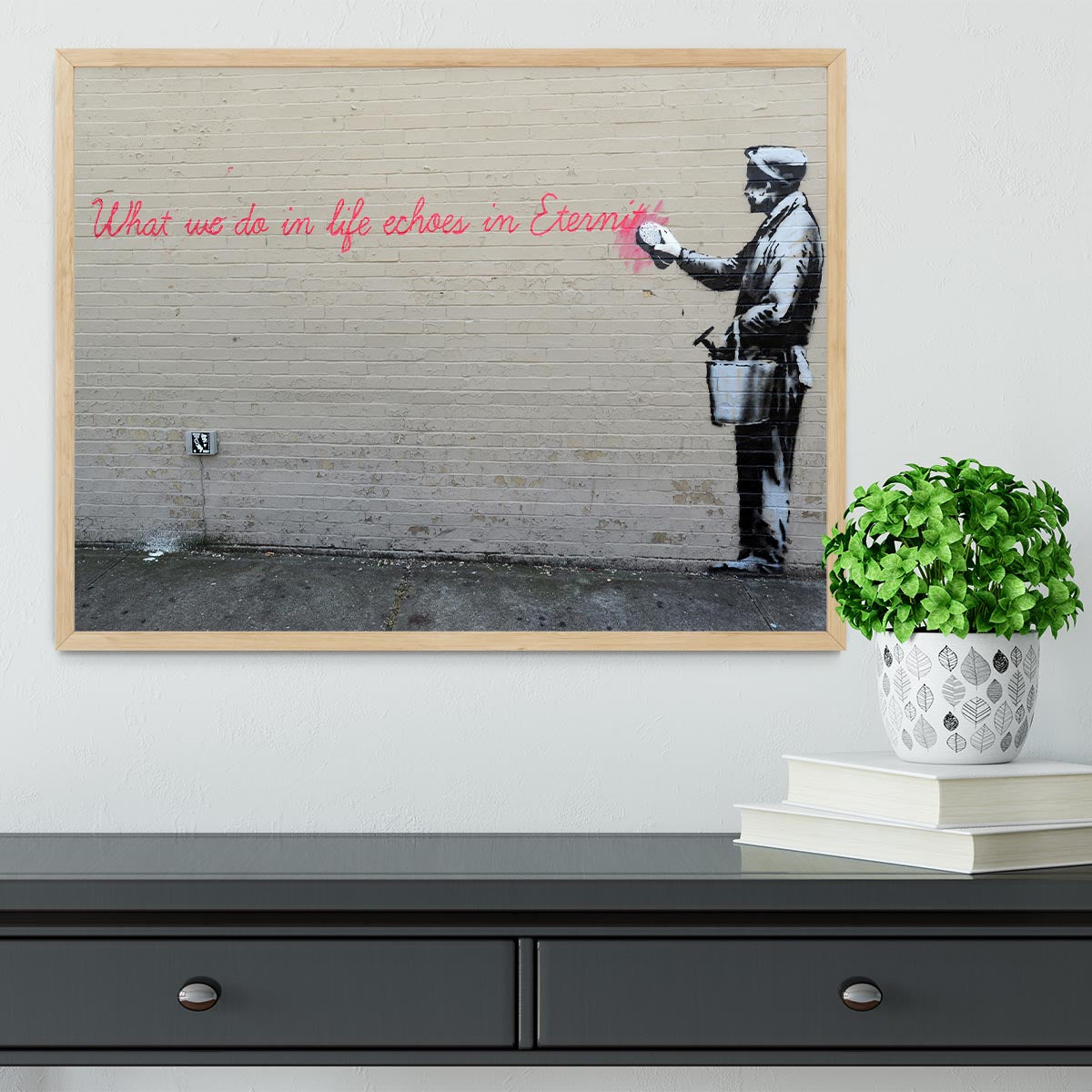 Banksy What We Do In Life Framed Print in a stylish black frame, showcasing vibrant colors and intricate details.