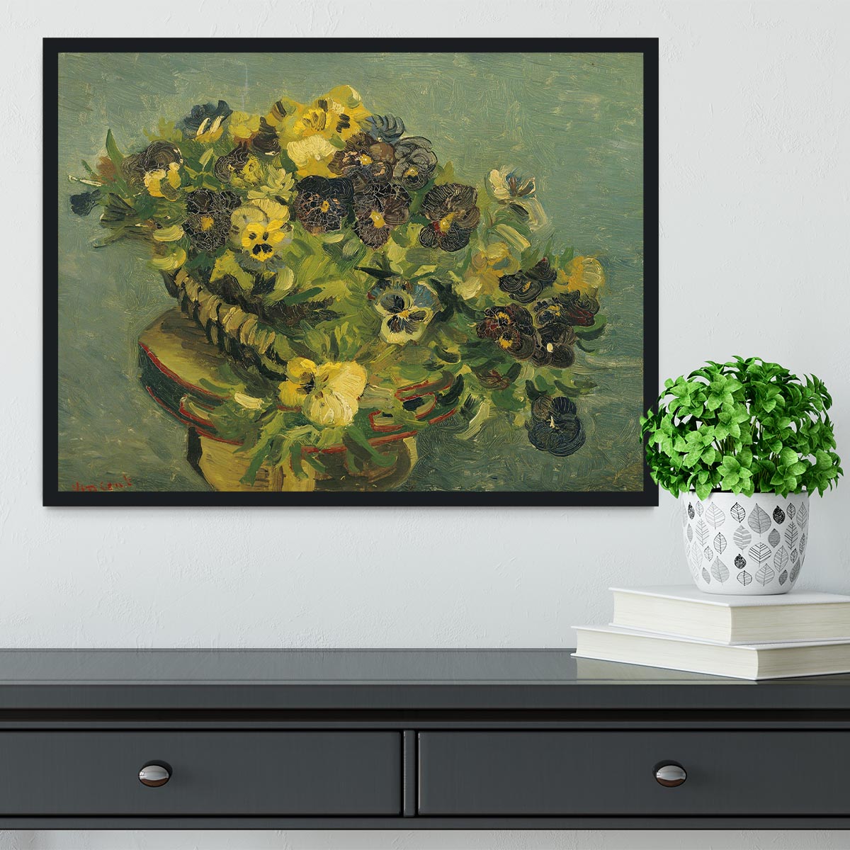 Framed print of Van Gogh's Basket of Pansies on a small table, showcasing vibrant colors and intricate details.