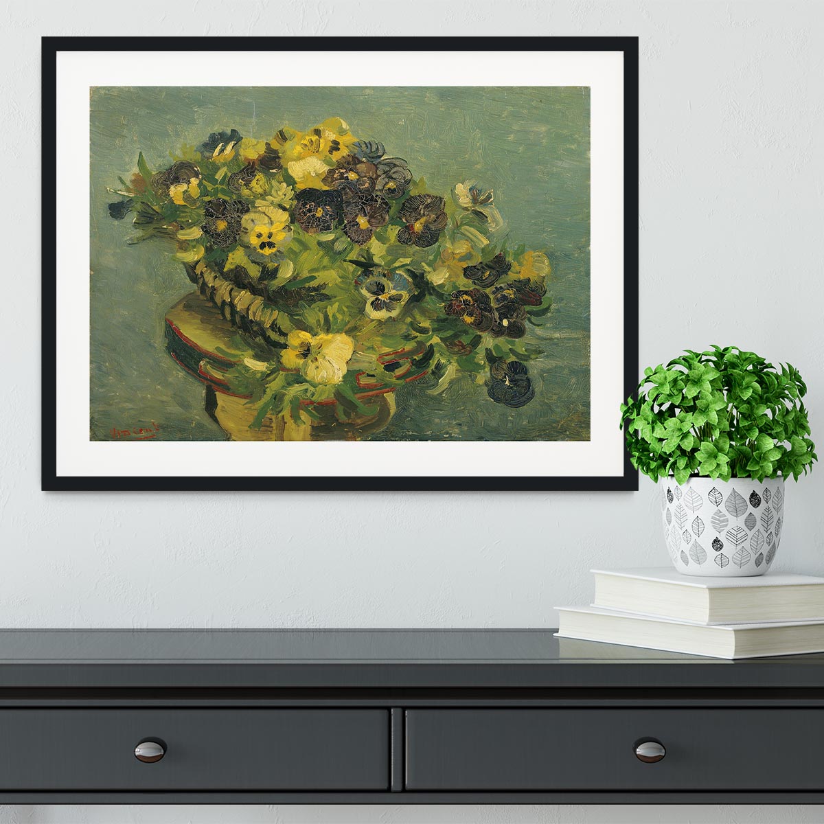 Framed print of Van Gogh's Basket of Pansies on a small table, showcasing vibrant colors and intricate details.