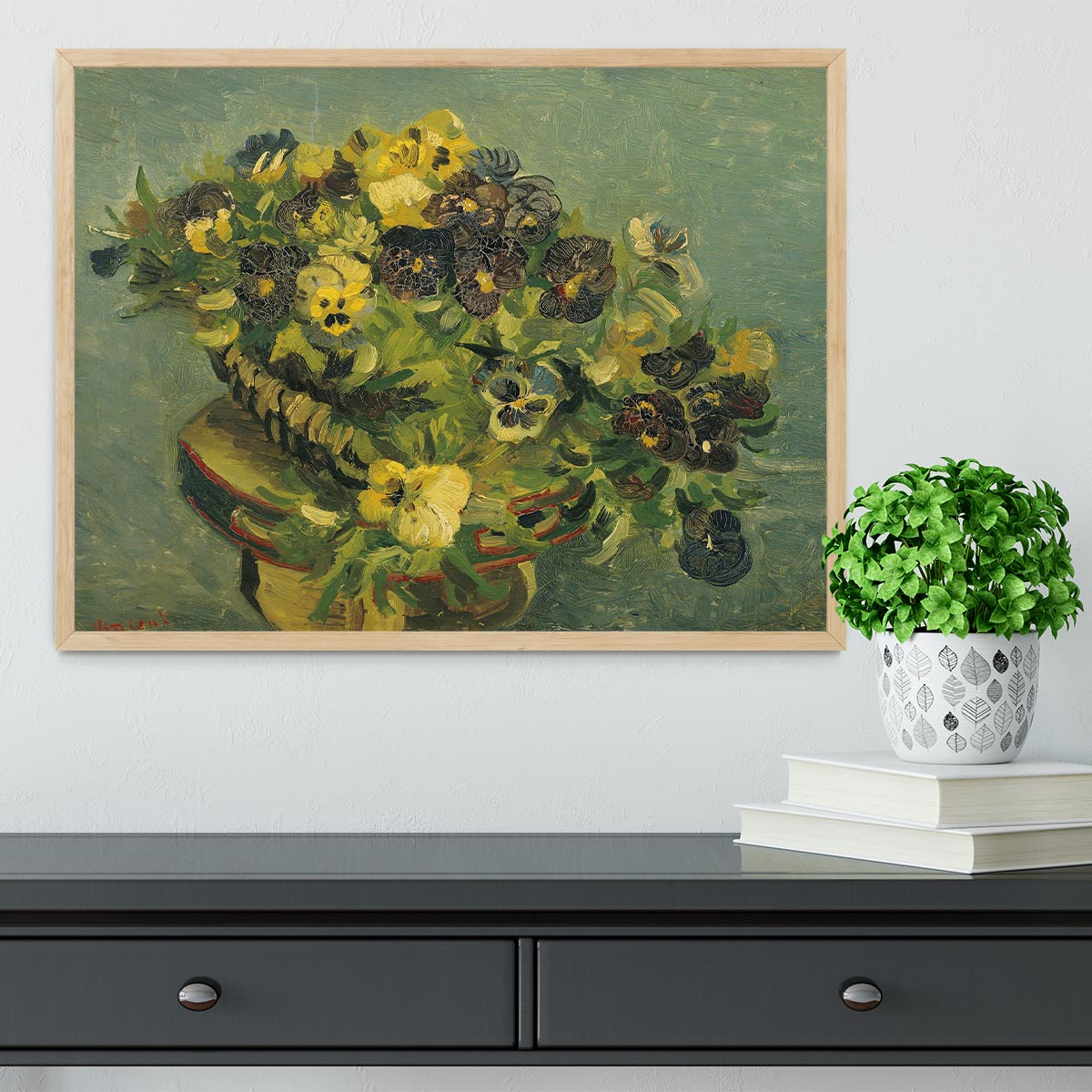 Framed print of Van Gogh's Basket of Pansies on a small table, showcasing vibrant colors and intricate details.