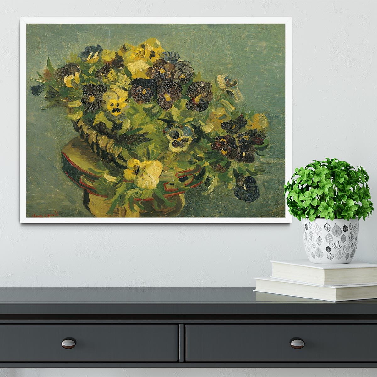 Framed print of Van Gogh's Basket of Pansies on a small table, showcasing vibrant colors and intricate details.