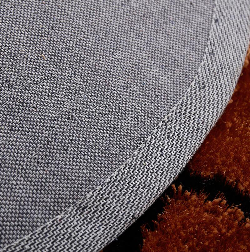 Basketball shape decorative area rug in brown and black, featuring a soft shaggy texture, perfect for kids' rooms.