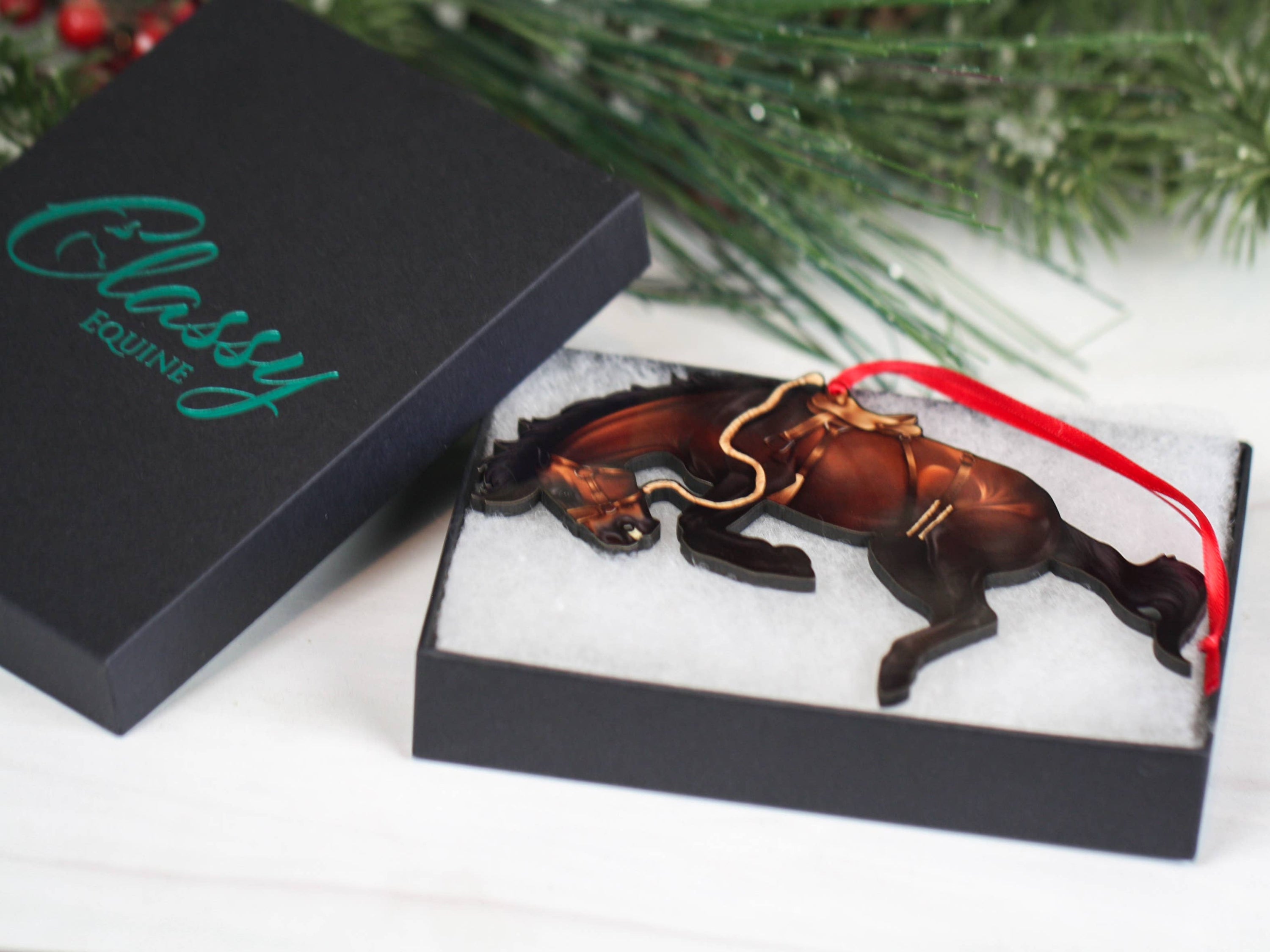 A beautifully crafted bay bucking horse ornament made from composite wood, showcasing intricate details and a glossy finish, perfect for western decor.