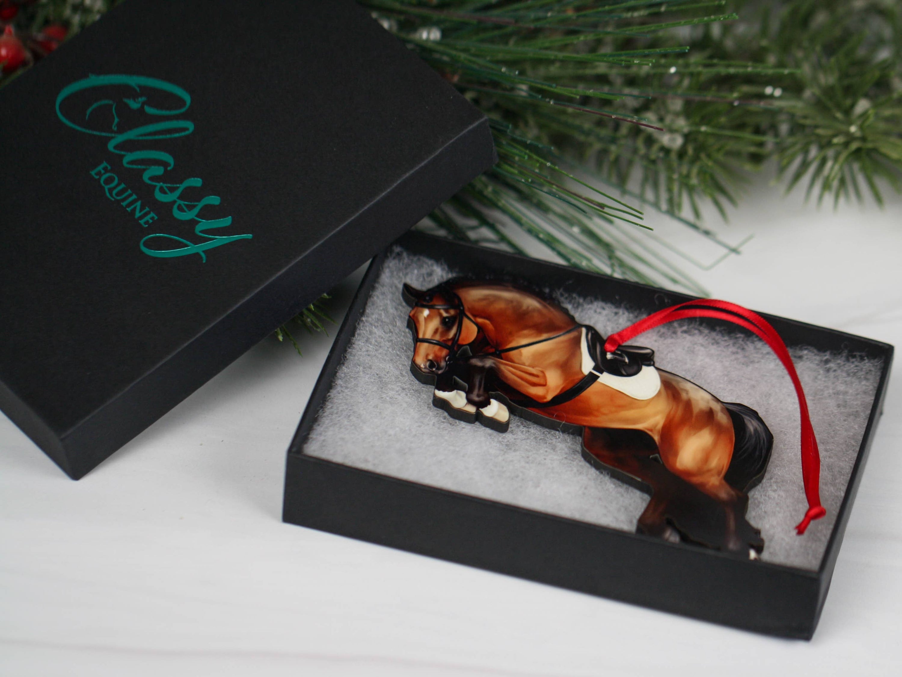 A beautifully crafted jumping horse ornament in bay color, made of composite wood, featuring a braided mane, perfect for Christmas decoration.