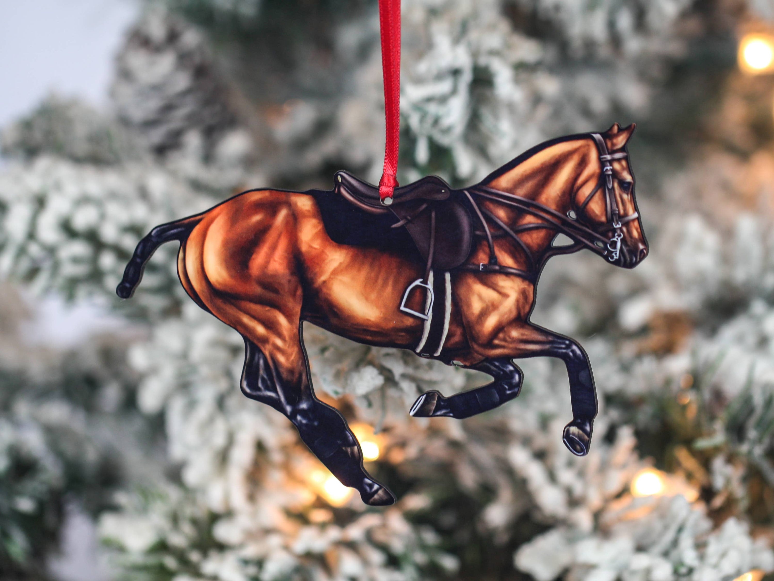 Handcrafted Bay Polo Pony Christmas Ornament with red and black ribbons, showcasing a galloping horse design, perfect for equestrian decor.