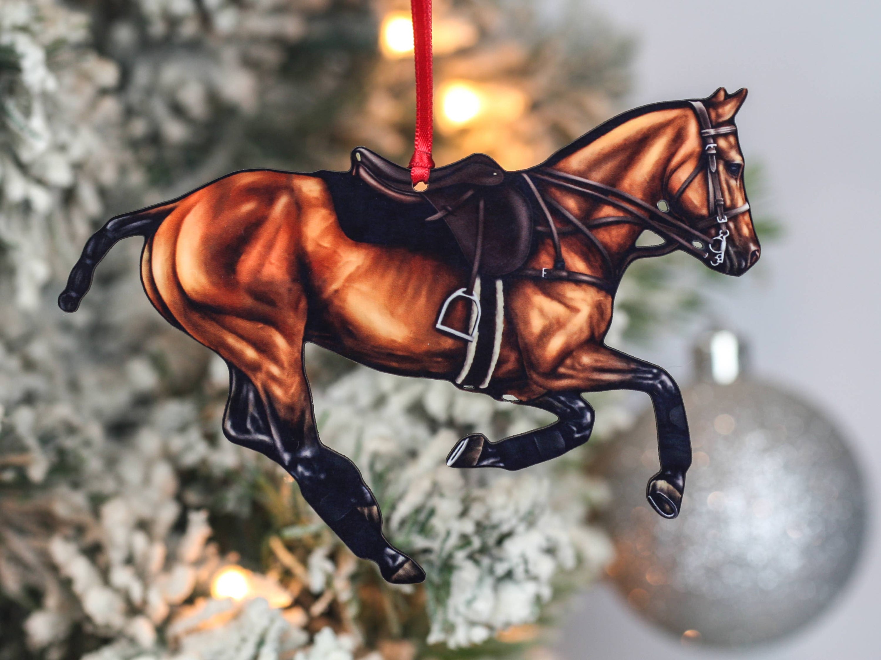 Handcrafted Bay Polo Pony Christmas Ornament with red and black ribbons, showcasing a galloping horse design, perfect for equestrian decor.