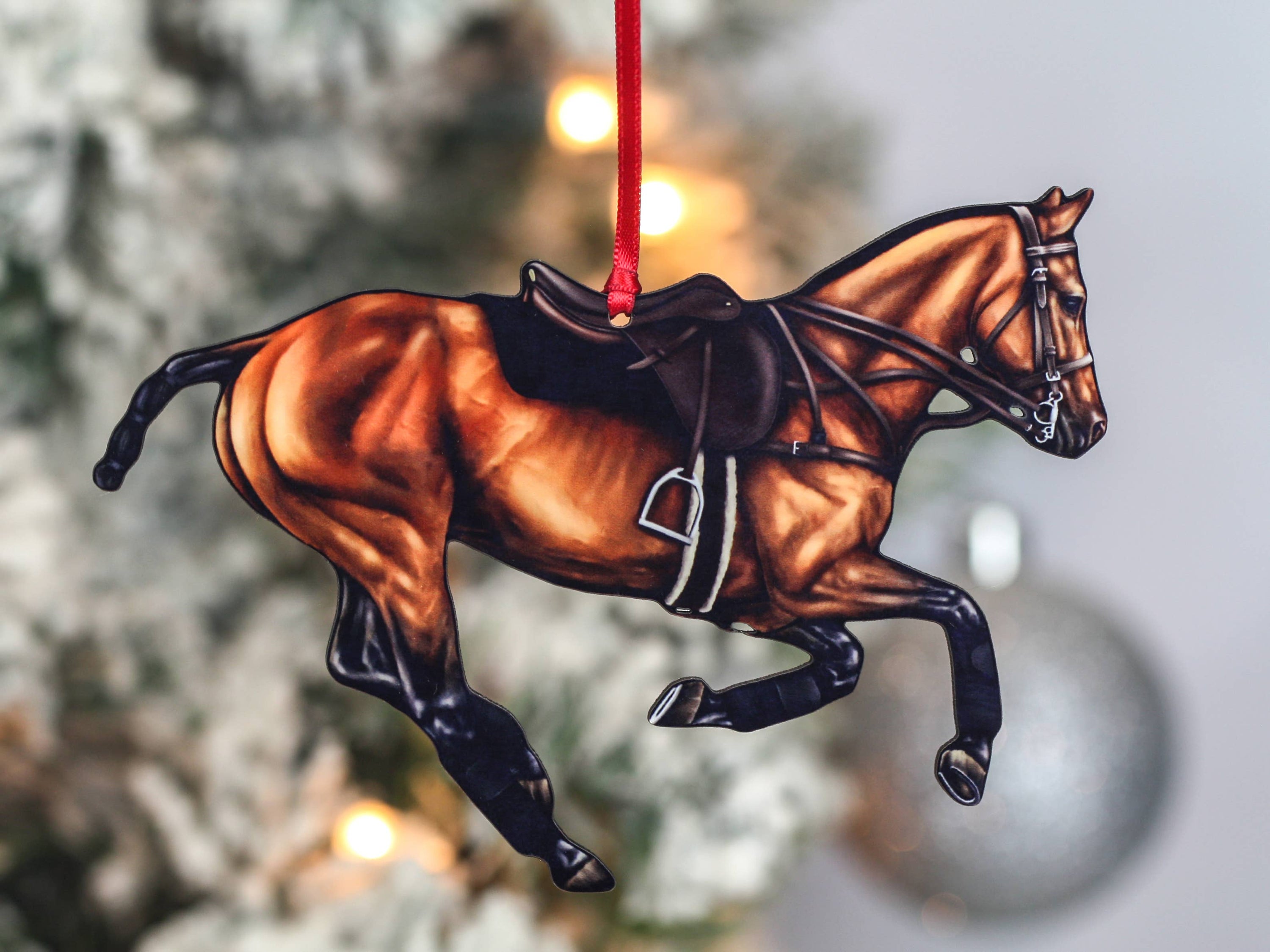 Handcrafted Bay Polo Pony Christmas Ornament with red and black ribbons, showcasing a galloping horse design, perfect for equestrian decor.