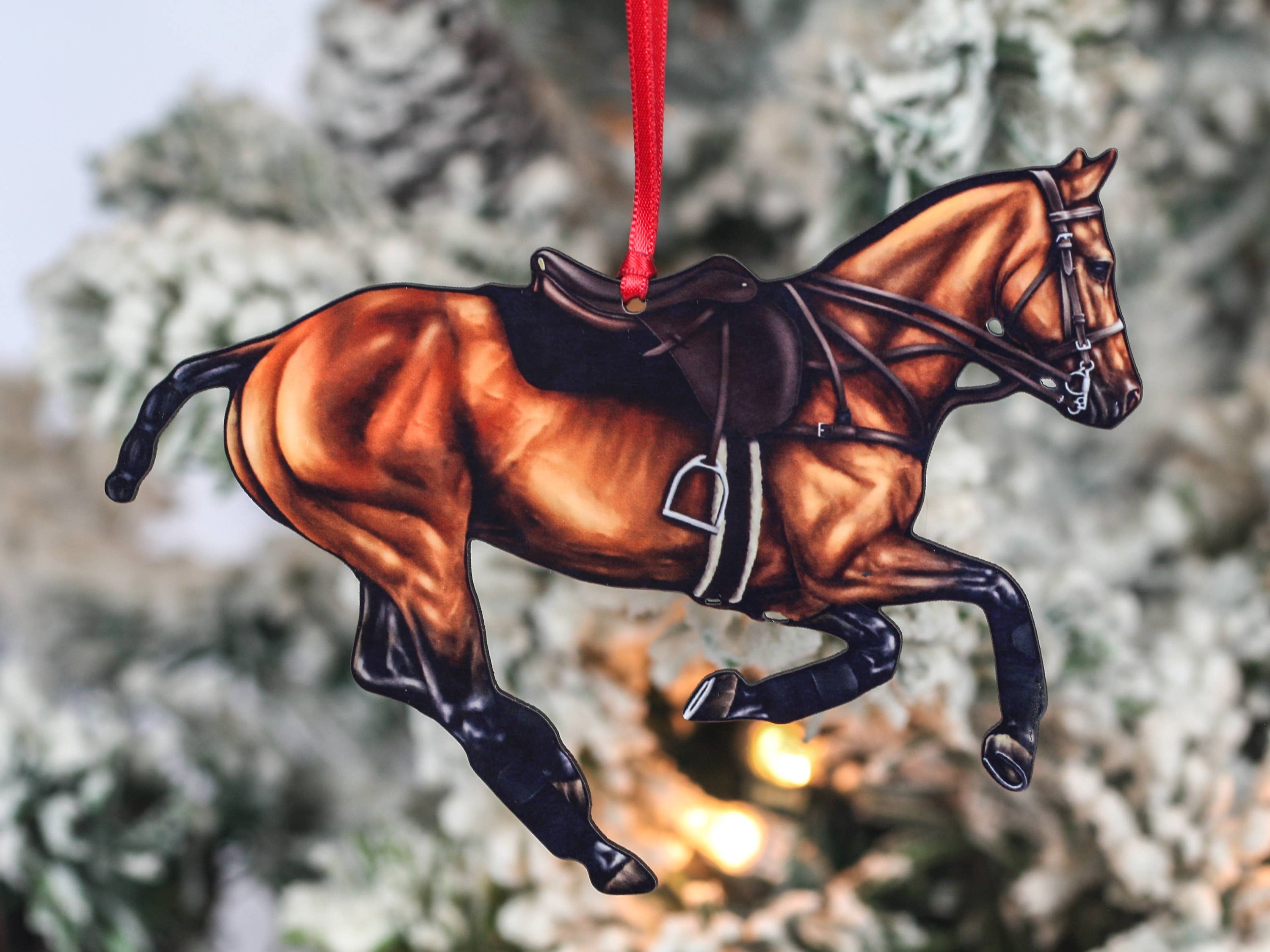 Handcrafted Bay Polo Pony Christmas Ornament with red and black ribbons, showcasing a galloping horse design, perfect for equestrian decor.