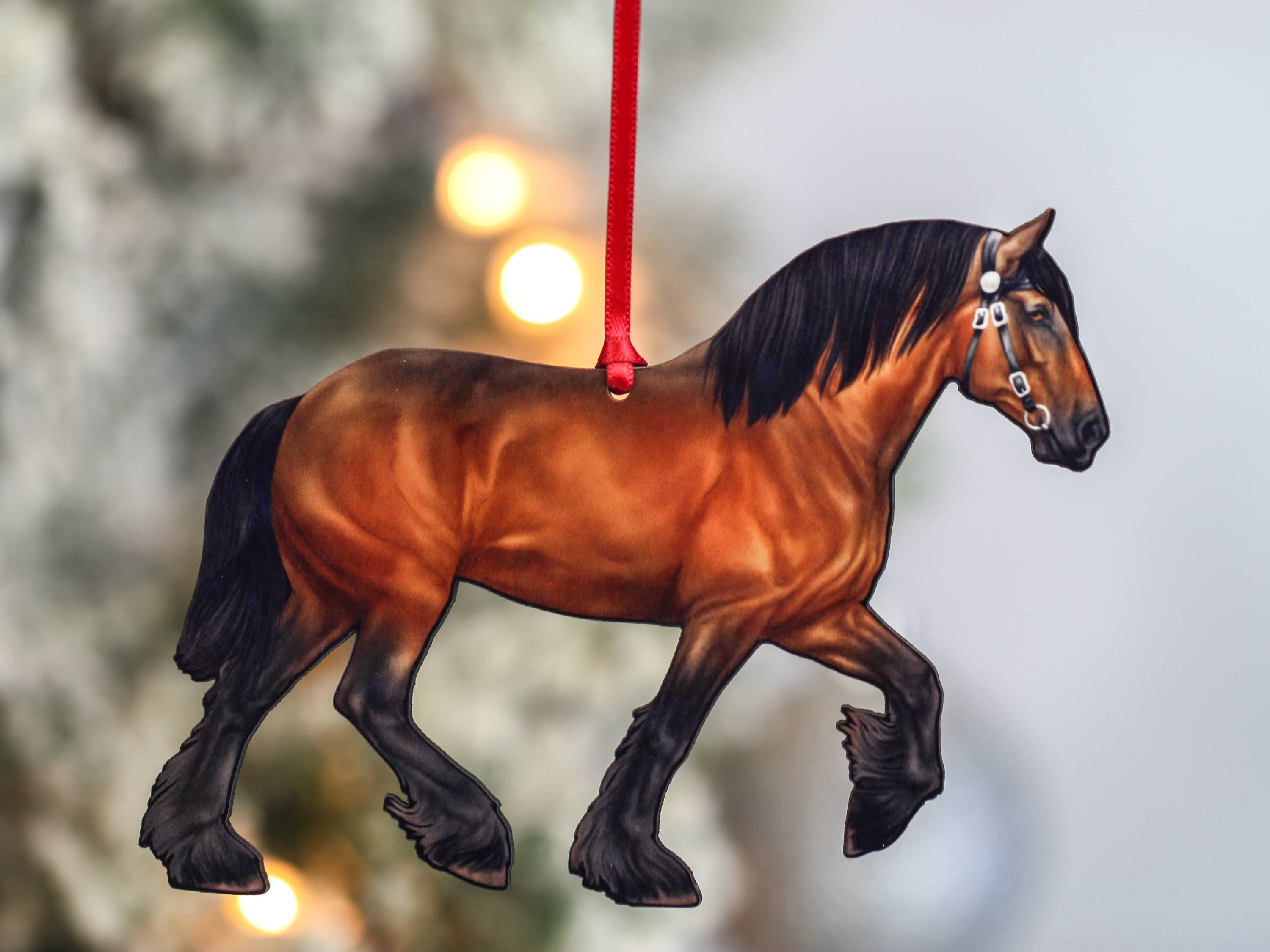 A beautifully crafted Bay Shire Draft Horse Ornament made from composite wood, featuring a glossy front and dark brown back, adorned with red and black ribbons.
