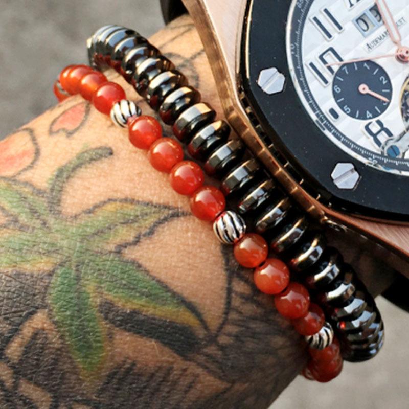 Men's 6mm hematite bracelet woven with nylon rope and red agate stones, showcasing a stylish and modern design.
