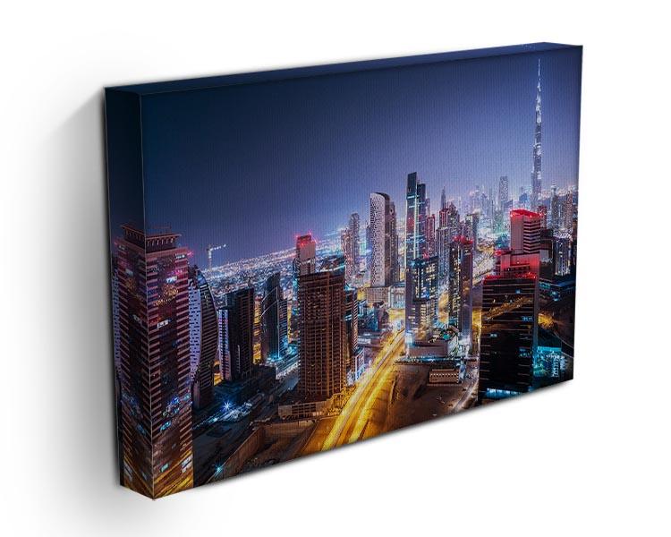 Beautiful night cityscape of Dubai canvas print showcasing vibrant lights and iconic buildings.