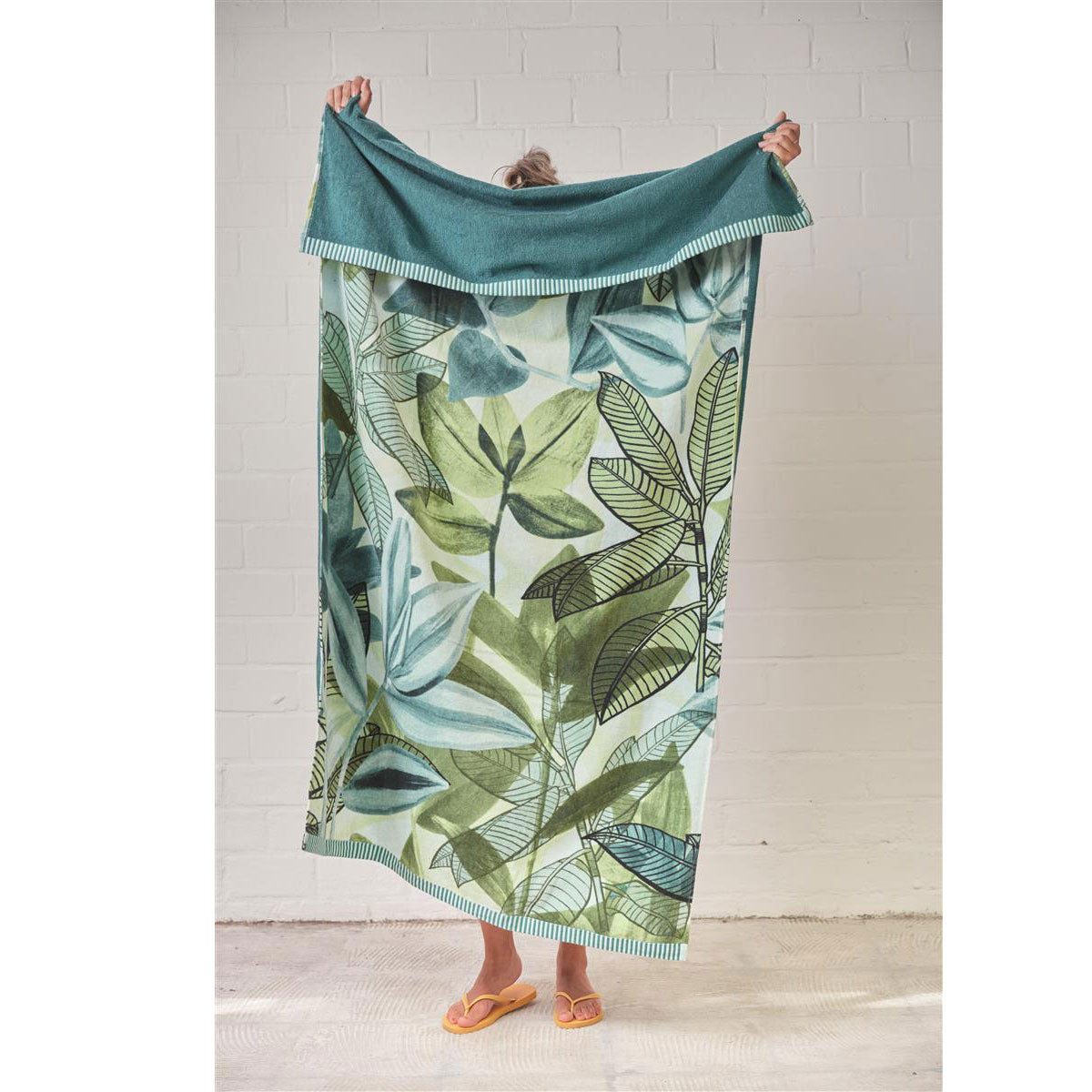 Bedding House Jungle Vibe Green Cotton Velour Beach Towel featuring a vibrant leaf print design and dark green back.