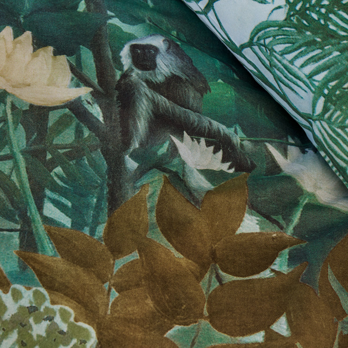 Madagascar Green Cotton Quilt Cover Set featuring a vibrant foliage print with tropical flowers and hidden monkeys, perfect for queen-sized beds.