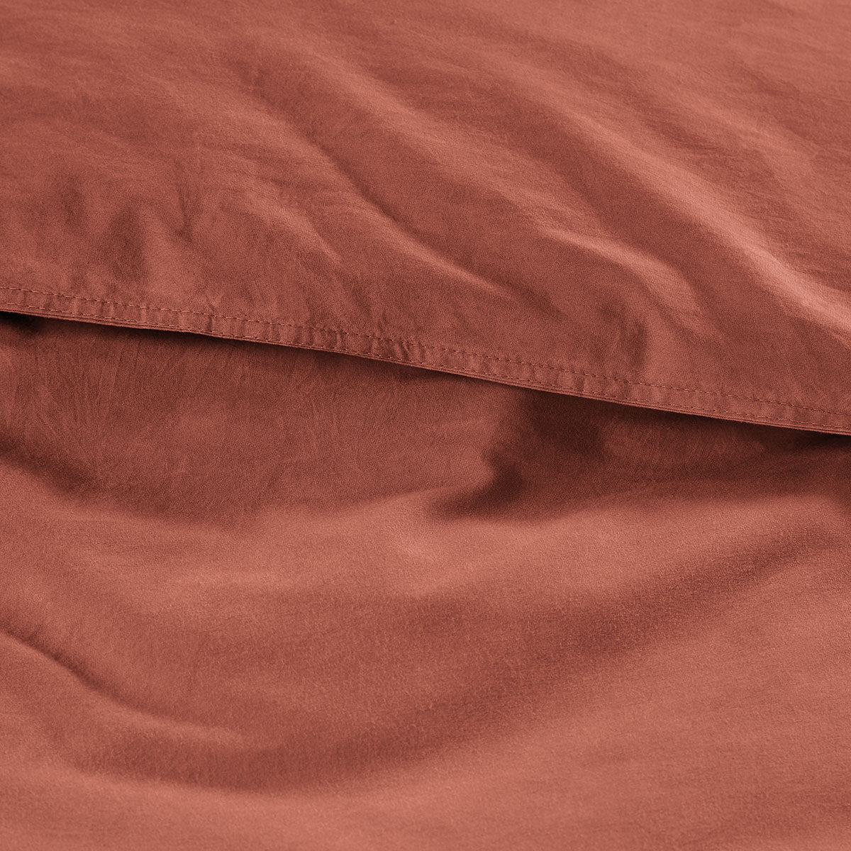 Bedding House Organic Cotton Basic Terracotta Quilt Cover Set featuring a quilt cover and two pillowcases in a warm terracotta color.