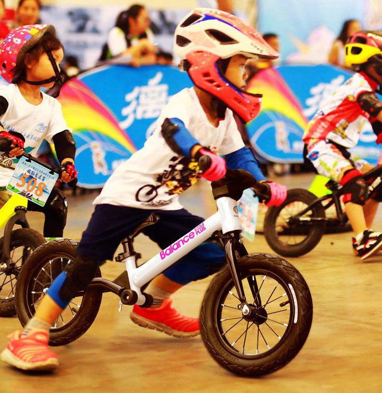 Bike Plus Kids Balance Bike in silver, featuring a lightweight aluminum frame, 12-inch spoked wheels, and an adjustable seat for children aged 2-6.