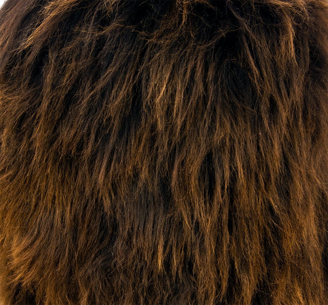 Birch wood and brown sheepskin ottoman showcasing natural materials and elegant design, perfect for modern and traditional interiors.