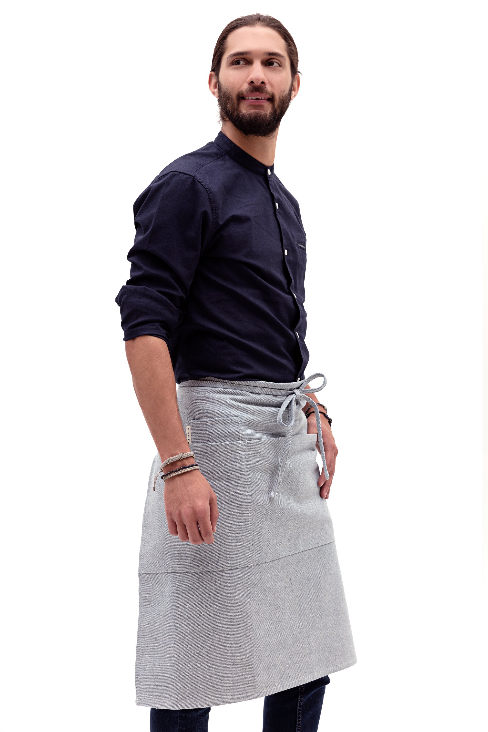 A stylish Bistro Apron featuring three large pockets, a small pocket, and a utility loop, made from 100% cotton with an eco-friendly design.