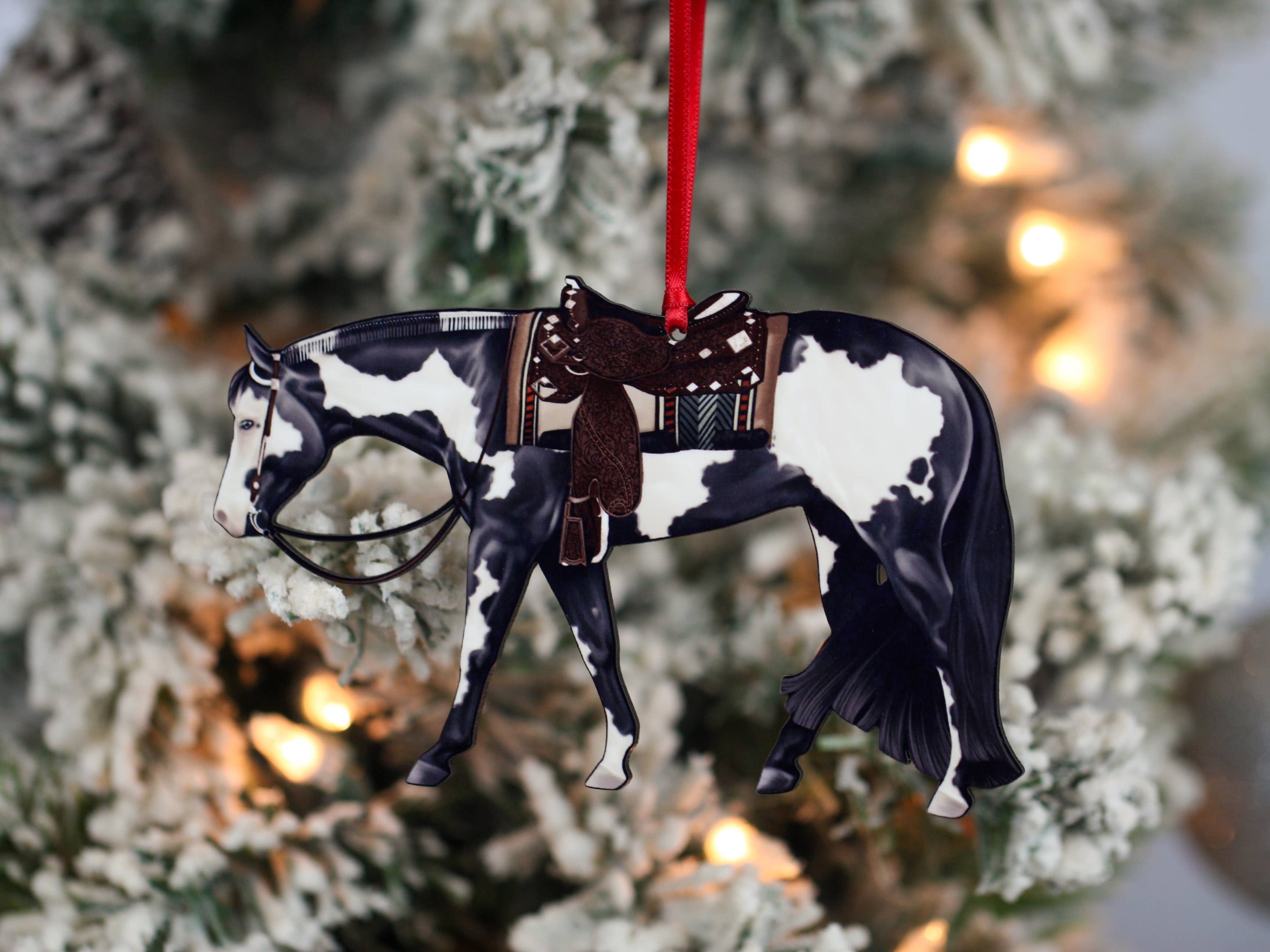 Black and white tobiano Paint Horse ornament, handmade from composite wood, featuring glossy front and dark brown back, perfect for holiday decor.