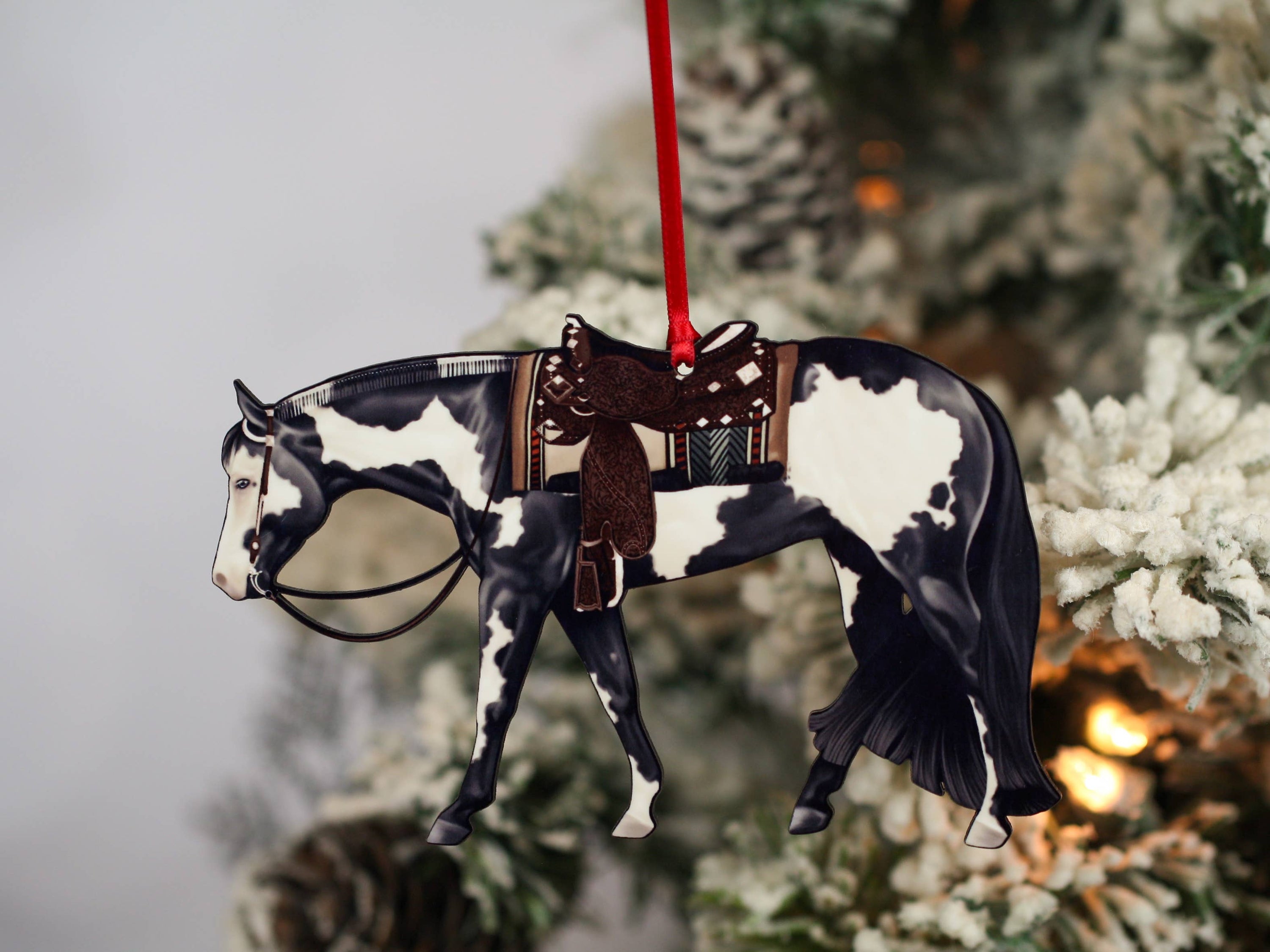 Black and white tobiano Paint Horse ornament, handmade from composite wood, featuring glossy front and dark brown back, perfect for holiday decor.