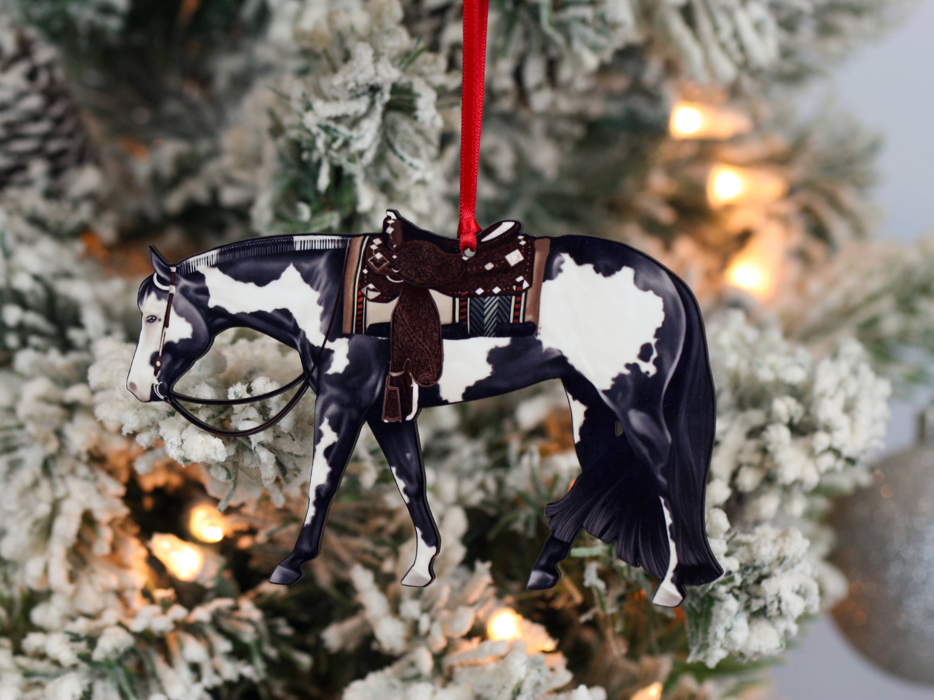 Black and white tobiano Paint Horse ornament, handmade from composite wood, featuring glossy front and dark brown back, perfect for holiday decor.