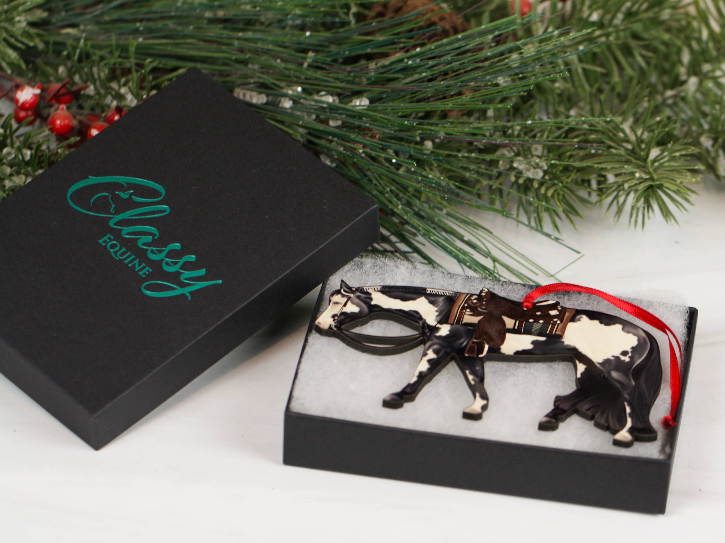 Black and white tobiano Paint Horse ornament, handmade from composite wood, featuring glossy front and dark brown back, perfect for holiday decor.