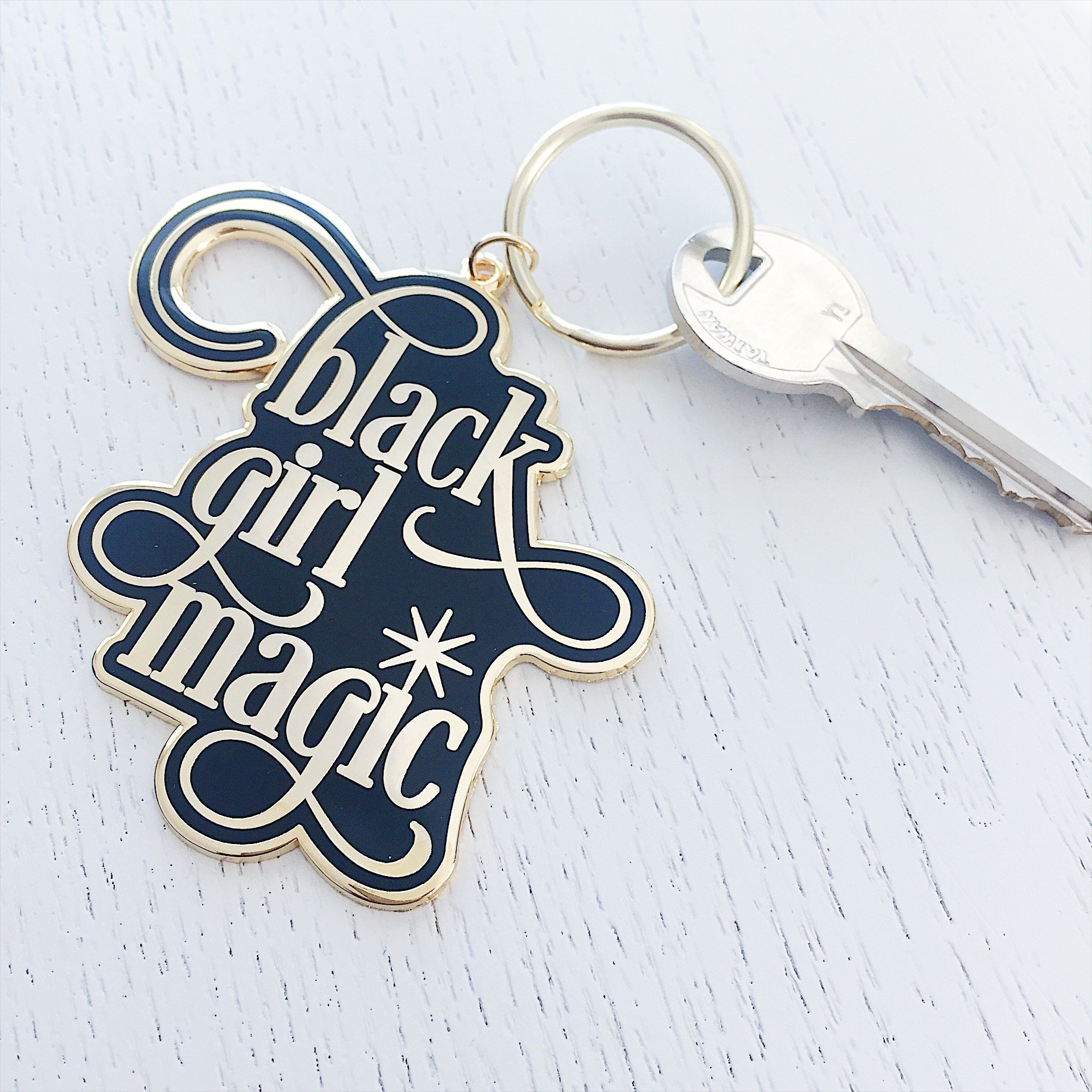 Black Girl Magic Enamel Keychain featuring a glossy finish and brass keyring, perfect for keys and bags.