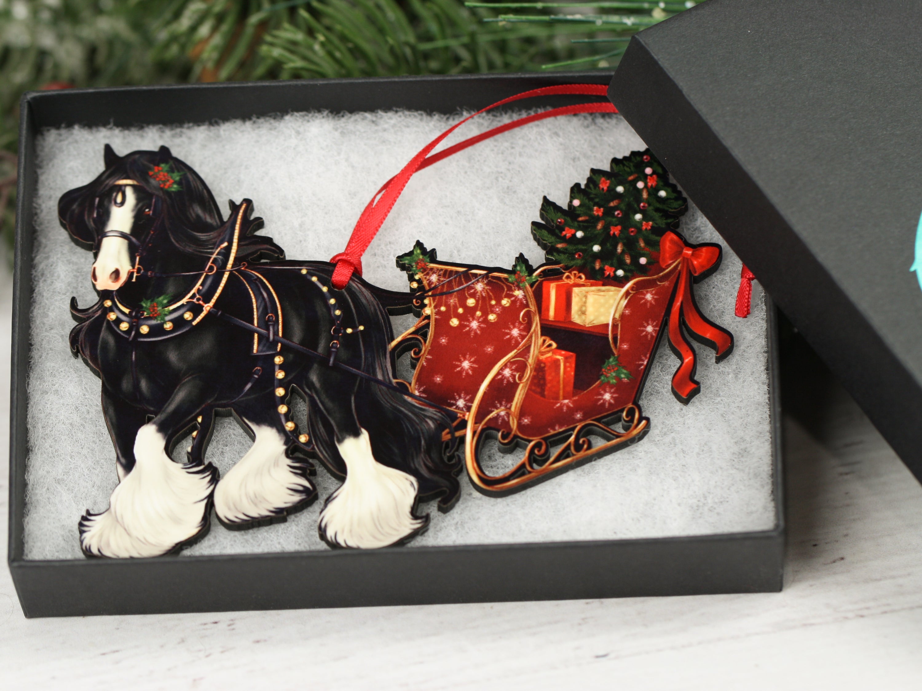 Black Gypsy Cob Horse Christmas Ornament with sleigh, handmade from composite wood, featuring a glossy front and dark brown back.