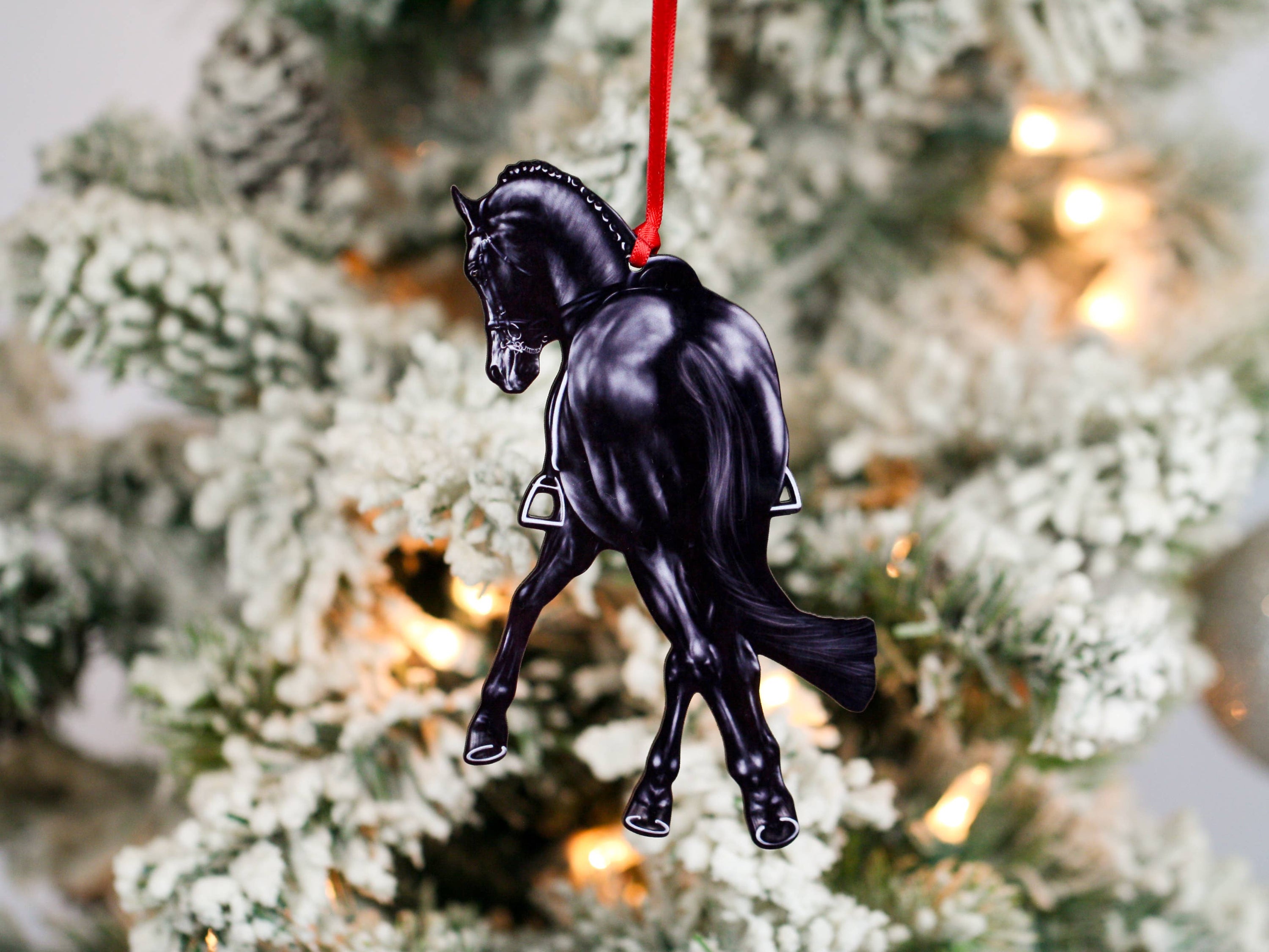 Black Half Pass Dressage Horse Ornament showcasing a horse in motion, made from composite wood with glossy finish and red and black ribbons.
