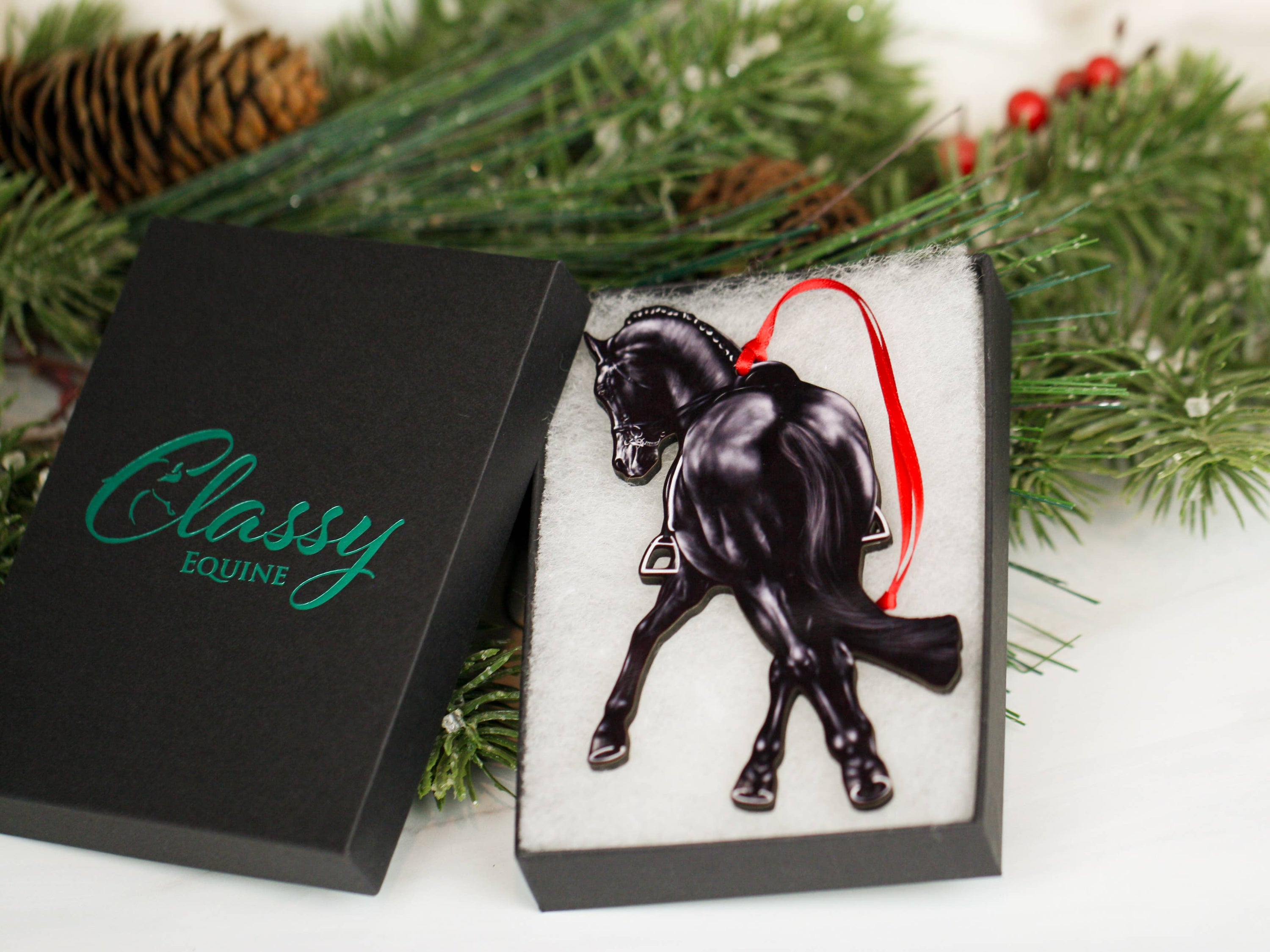 Black Half Pass Dressage Horse Ornament showcasing a horse in motion, made from composite wood with glossy finish and red and black ribbons.