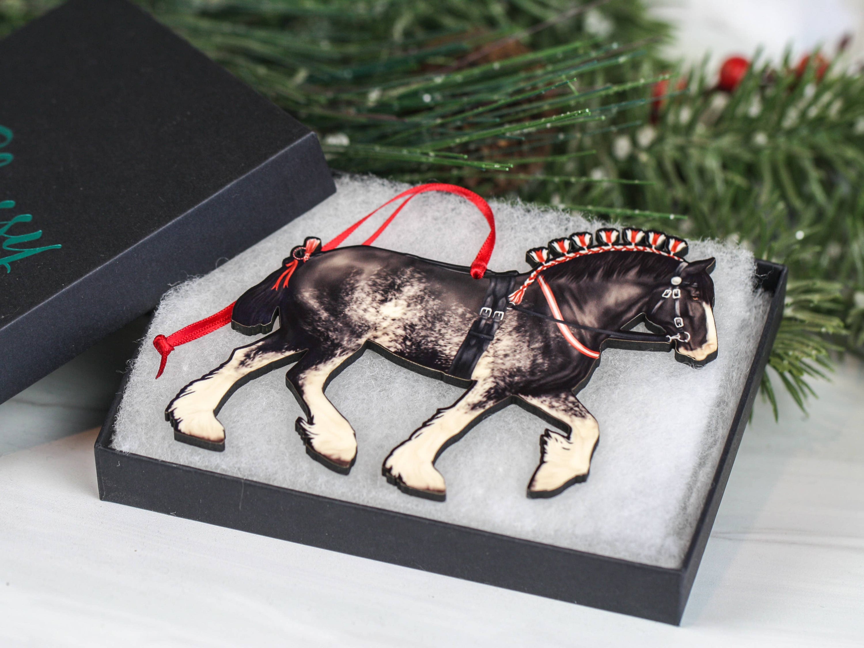 Handcrafted Black Sabino Shire Draft Horse Christmas Ornament with red and black ribbons, showcasing intricate laser-cut details.