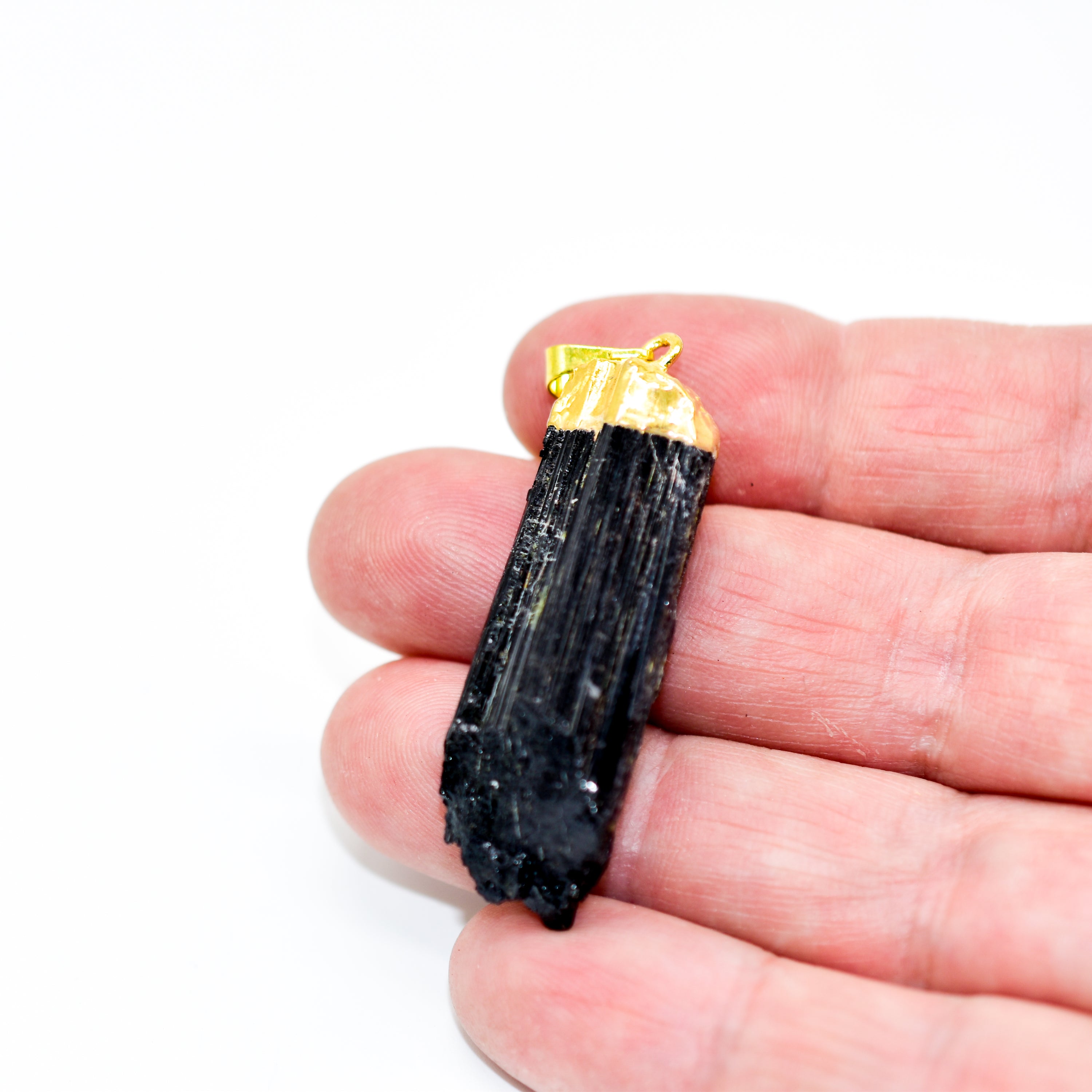 A stunning Black Tourmaline Pendant Necklace showcasing a natural black tourmaline stone set in a sleek design, perfect for spiritual protection.