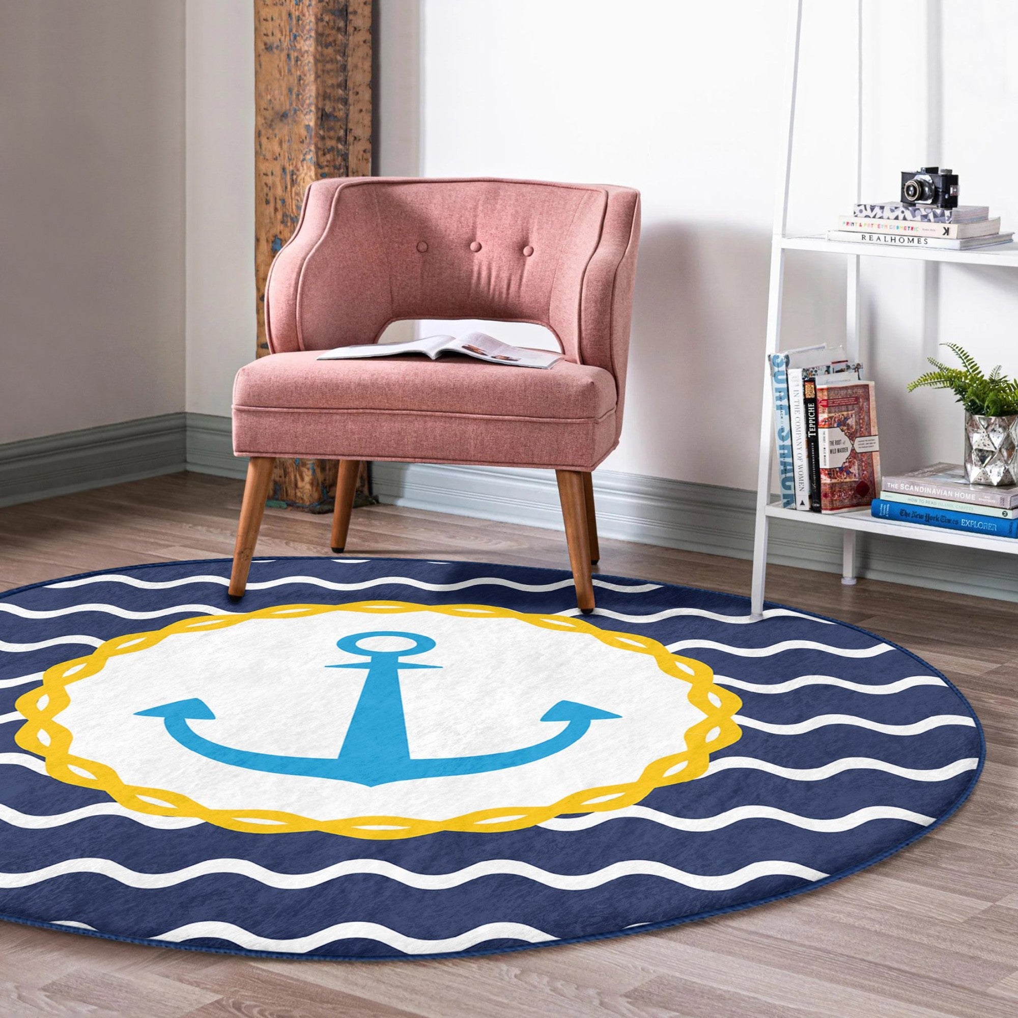 A round rug featuring a deep blue anchor pattern, perfect for marine-themed decor, showcasing its soft texture and vibrant colors.