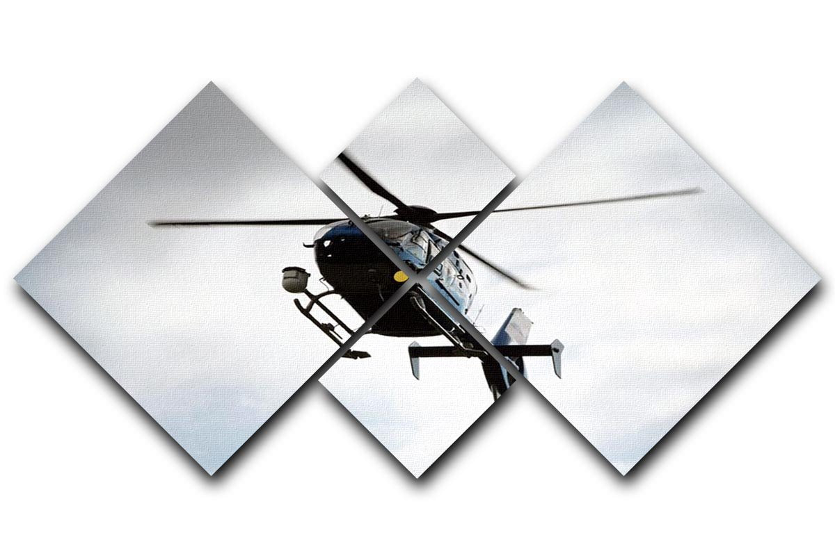 A blue and silver police helicopter flying above a 4-square canvas artwork, showcasing vibrant colors and modern design.