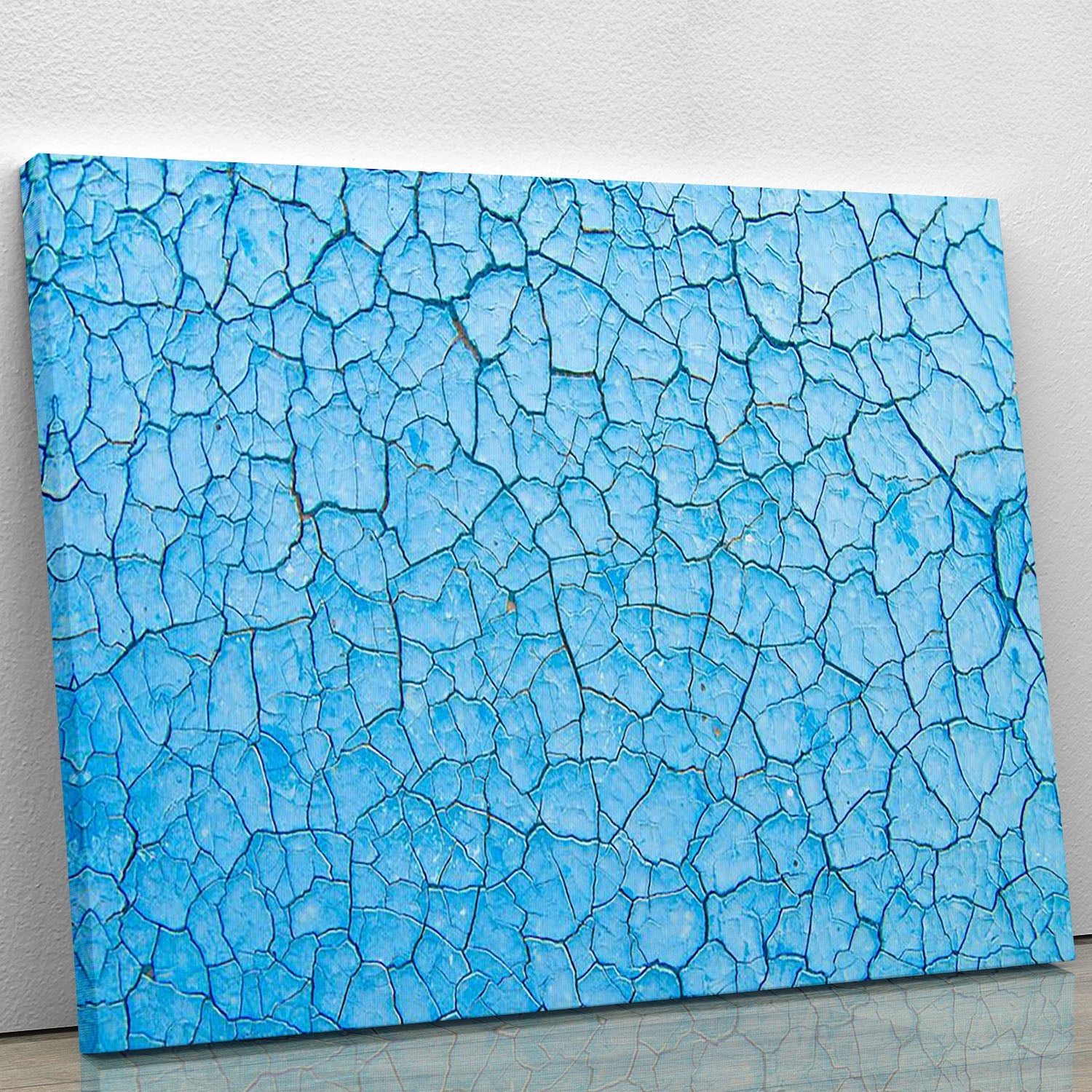 A vibrant blue cracked paint canvas print showcasing modern abstract art, perfect for home decor.