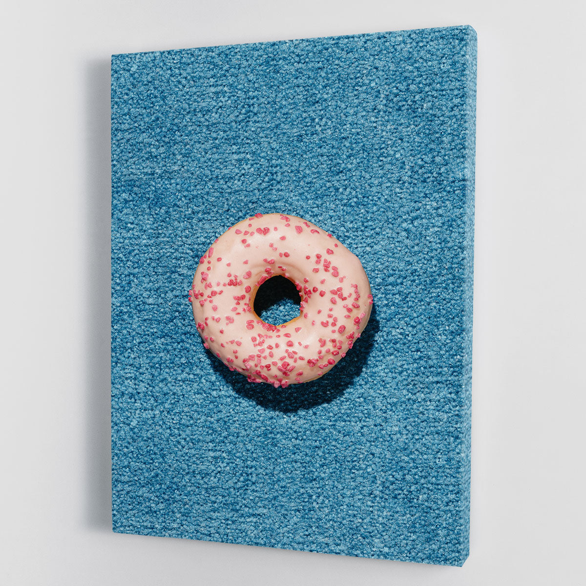 A vibrant blue doughnut canvas print showcasing modern art design, perfect for home or office decor.