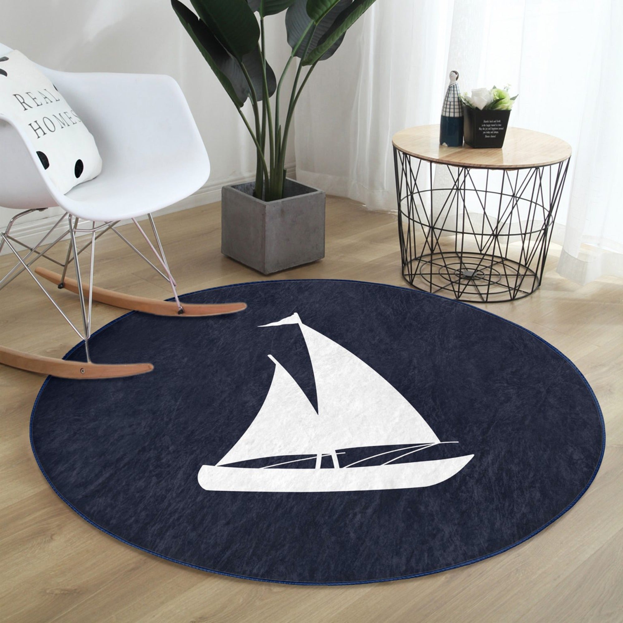 A round rug featuring a blue sail pattern, showcasing its soft velvet texture and vibrant colors, perfect for home decoration.
