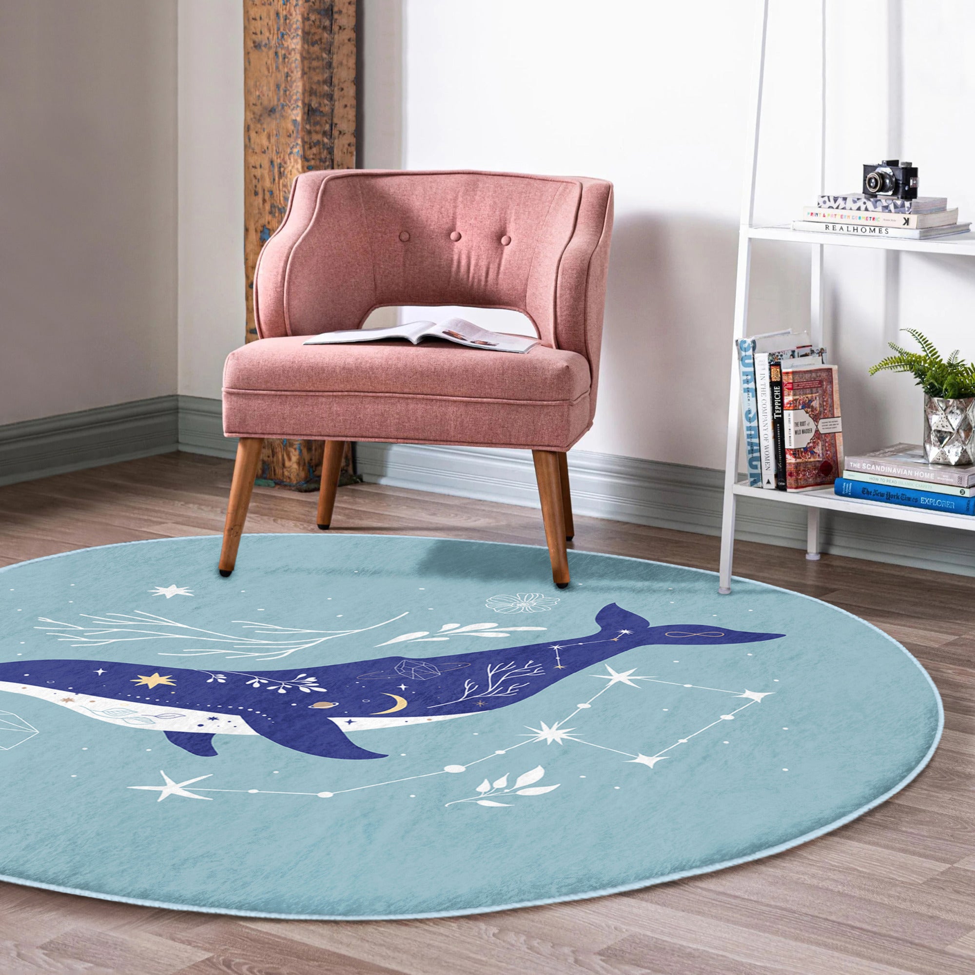 A soft, round rug featuring a vibrant blue whale pattern, perfect for kids' rooms and nurseries, showcasing its plush texture and colorful design.