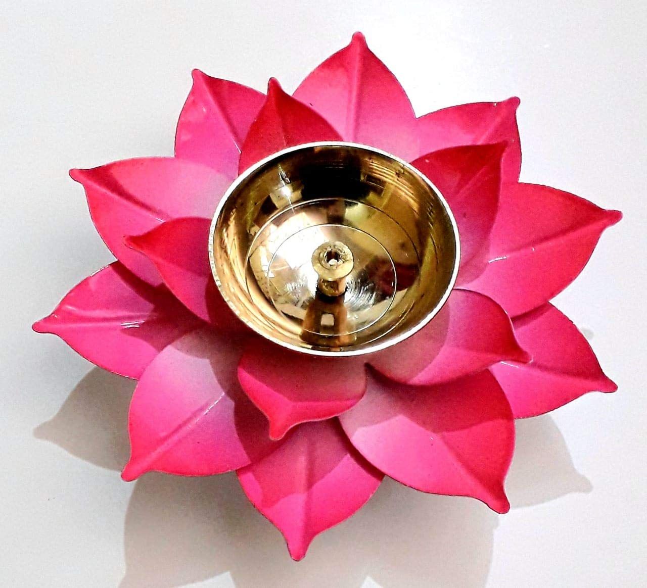 Handcrafted pink brass diya featuring an elegant lotus flower design, symbolizing spiritual growth.