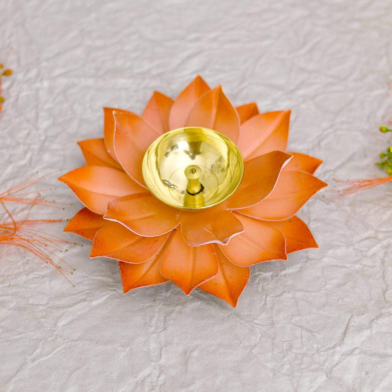 A beautifully handcrafted Brass Lotus Diya in vibrant red and yellow colors, featuring an elegant lotus flower design.