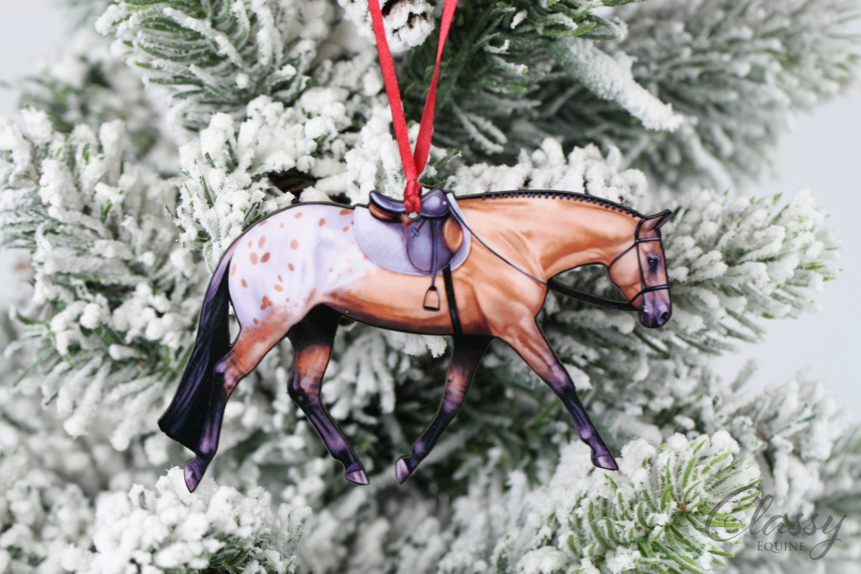 A beautifully crafted buckskin Appaloosa horse ornament with a spotted blanket, made from composite wood, perfect for display.