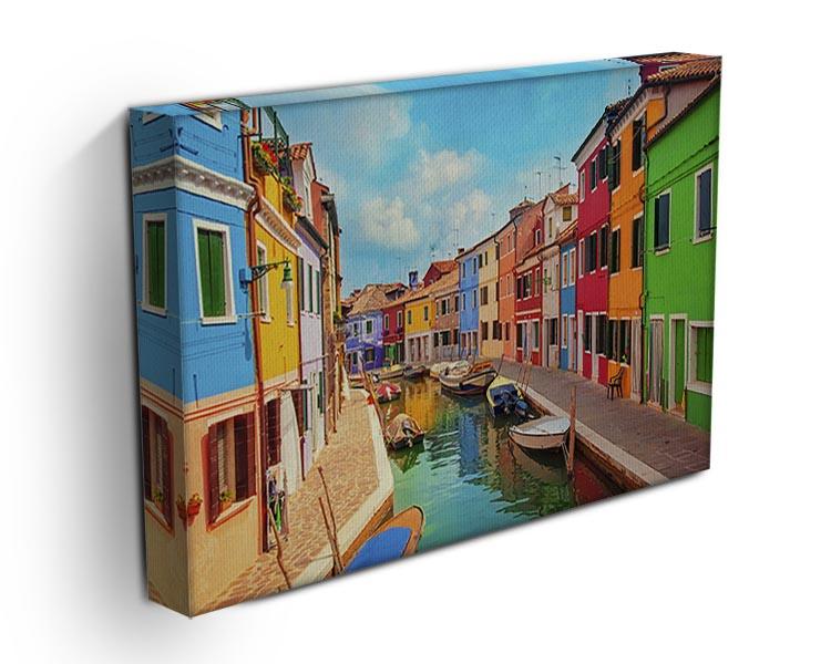A vibrant canvas print of the Burano Venetian Lagoon showcasing colorful houses and serene waters, perfect for home decor.