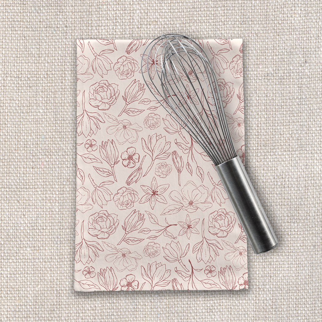 Burgundy Magnolia Tea Towel featuring a floral design on soft cotton twill, perfect for kitchen use and decoration.