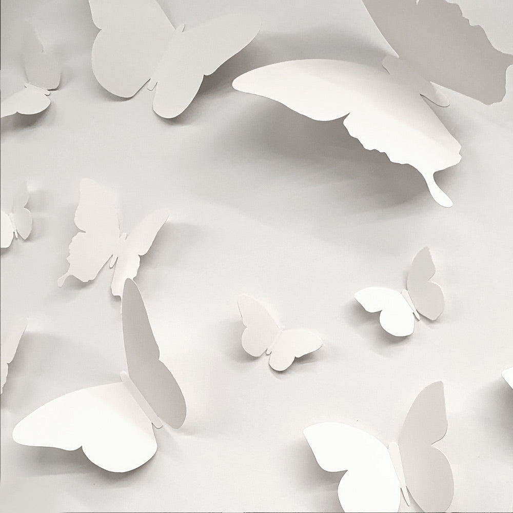 A colorful assortment of 18 cardboard 3D decorative butterflies in various sizes, perfect for wall decoration.