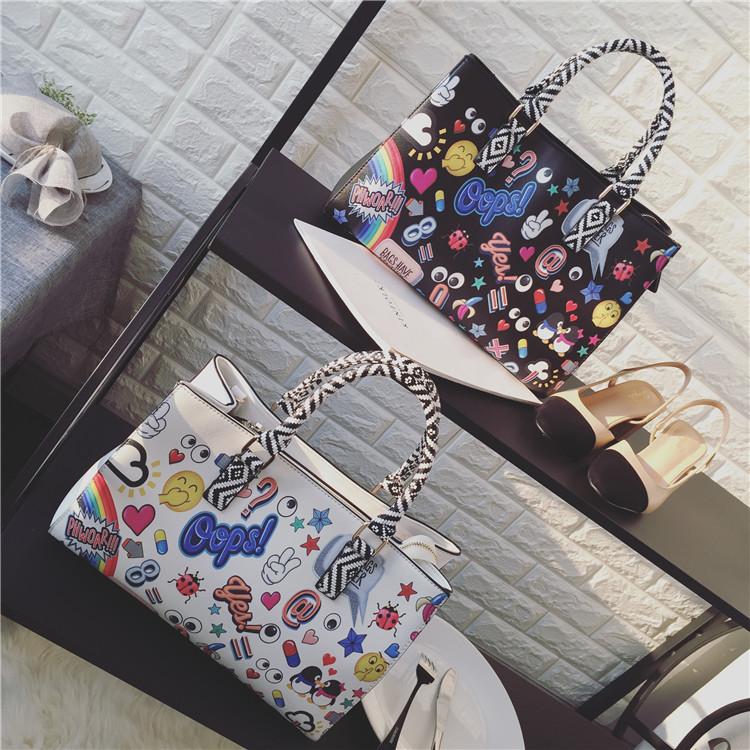 Stylish cartoon print graffiti handbag with large capacity, featuring vibrant colors and artistic designs, perfect for women.